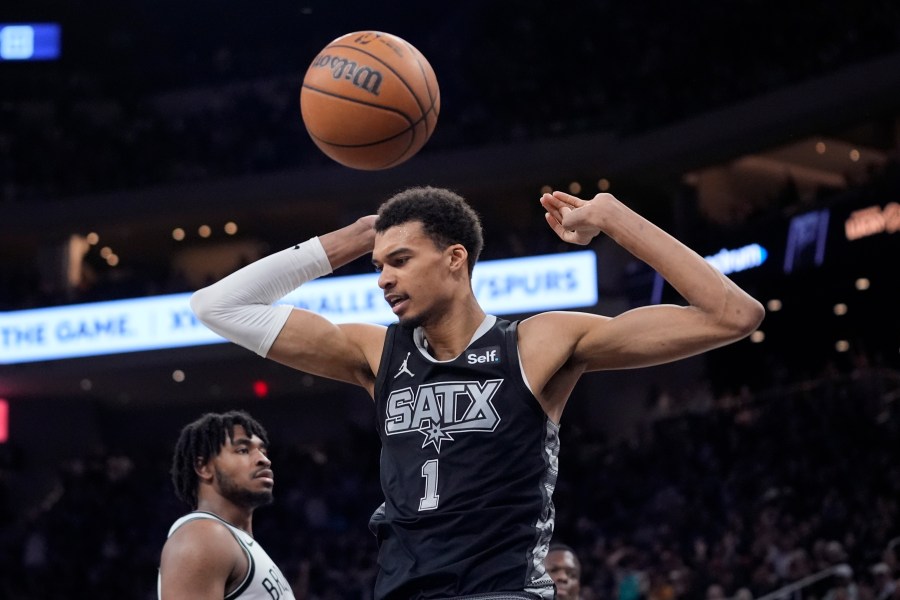 San Antonio Spurs center Victor Wembanyama (1) scores against the Brooklyn Nets during the second half of an NBA basketball game in Austin, Texas, Sunday, March 17, 2024. (AP Photo/Eric Gay)