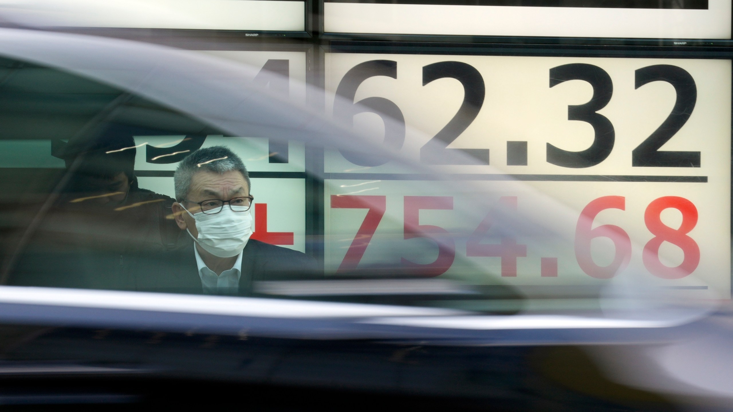 A person stands in front of an electronic stock board showing Japan's Nikkei 225 index at a securities firm Monday, March 18, 2024, in Tokyo. Asian stocks advanced Monday ahead of policy decisions this week by Japan’s central bank and the Federal Reserve. (AP Photo/Eugene Hoshiko)