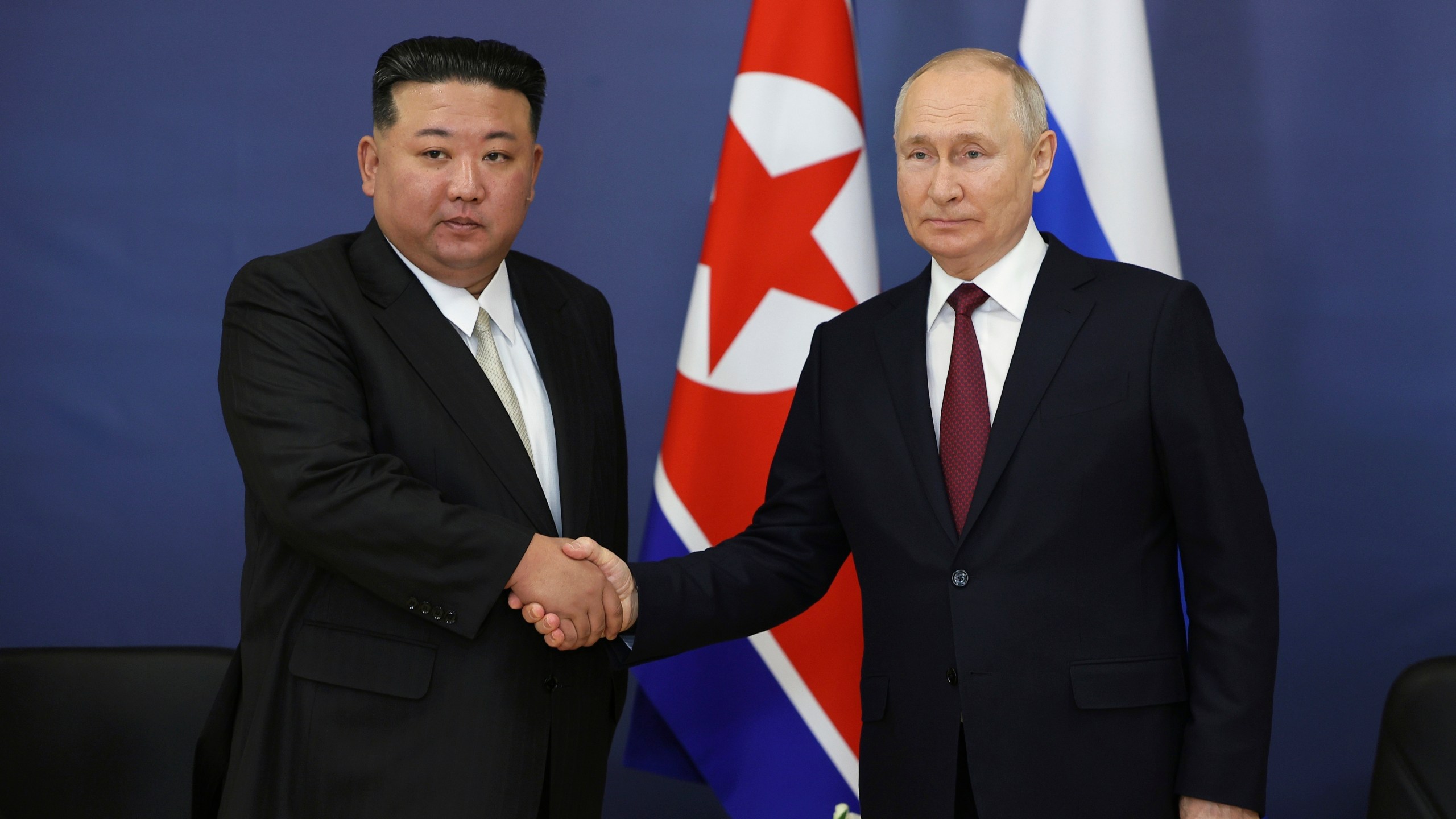 FILE - Russian President Vladimir Putin, right, and North Korean leader Kim Jong Un shake hands during their meeting at the Vostochny cosmodrome outside the city of Tsiolkovsky, about 200 kilometers (125 miles) from the city of Blagoveshchensk in the far eastern Amur region, Russia on Sept. 13, 2023. North Korea has shipped around 7,000 containers filled with munitions and other military equipment to Russia since 2023 to help support its war in Ukraine, South Korea’s defense minister said Monday, March 18, 2024. (Vladimir Smirnov/Sputnik Kremlin Pool Photo via AP, File)