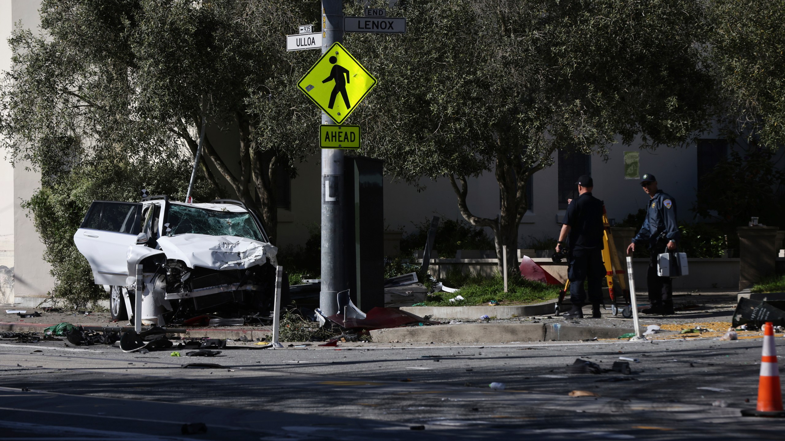 The area around a bus stop near Muni's West Portal Station is fenced off after a sport utility vehicle crashed into the stop, killing multiple people and injuring others, Saturday, March 16, 2024. (Benjamin Fanjoy/San Francisco Chronicle via AP)