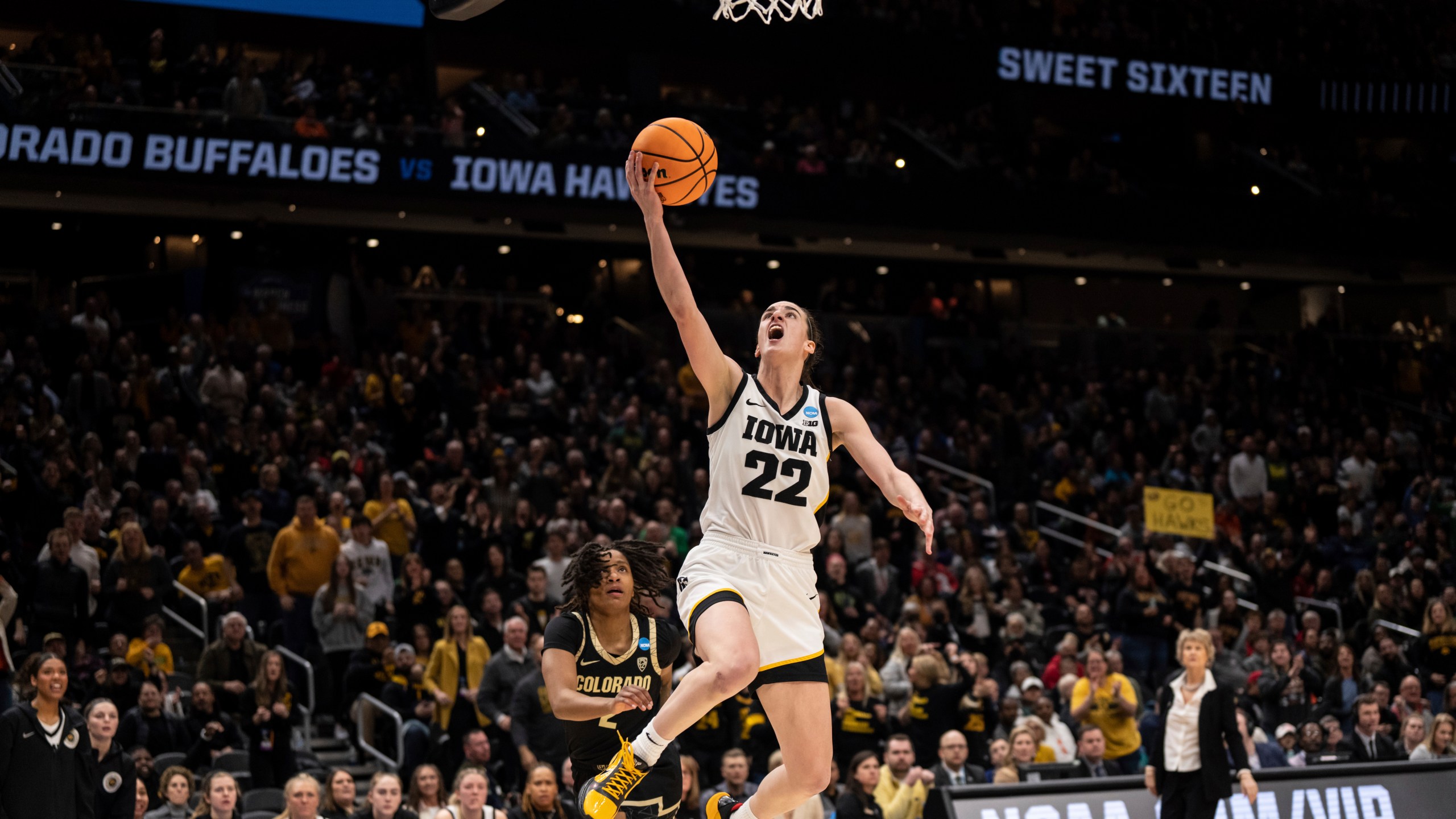 FILE - Iowa guard Caitlin Clark (22) goes up for a layup against Colorado guard Tameiya Sadler during the second half of a Sweet 16 college basketball game of the NCAA tournament, Friday, March 24, 2023, in Seattle.(AP Photo/Stephen Brashear, File)