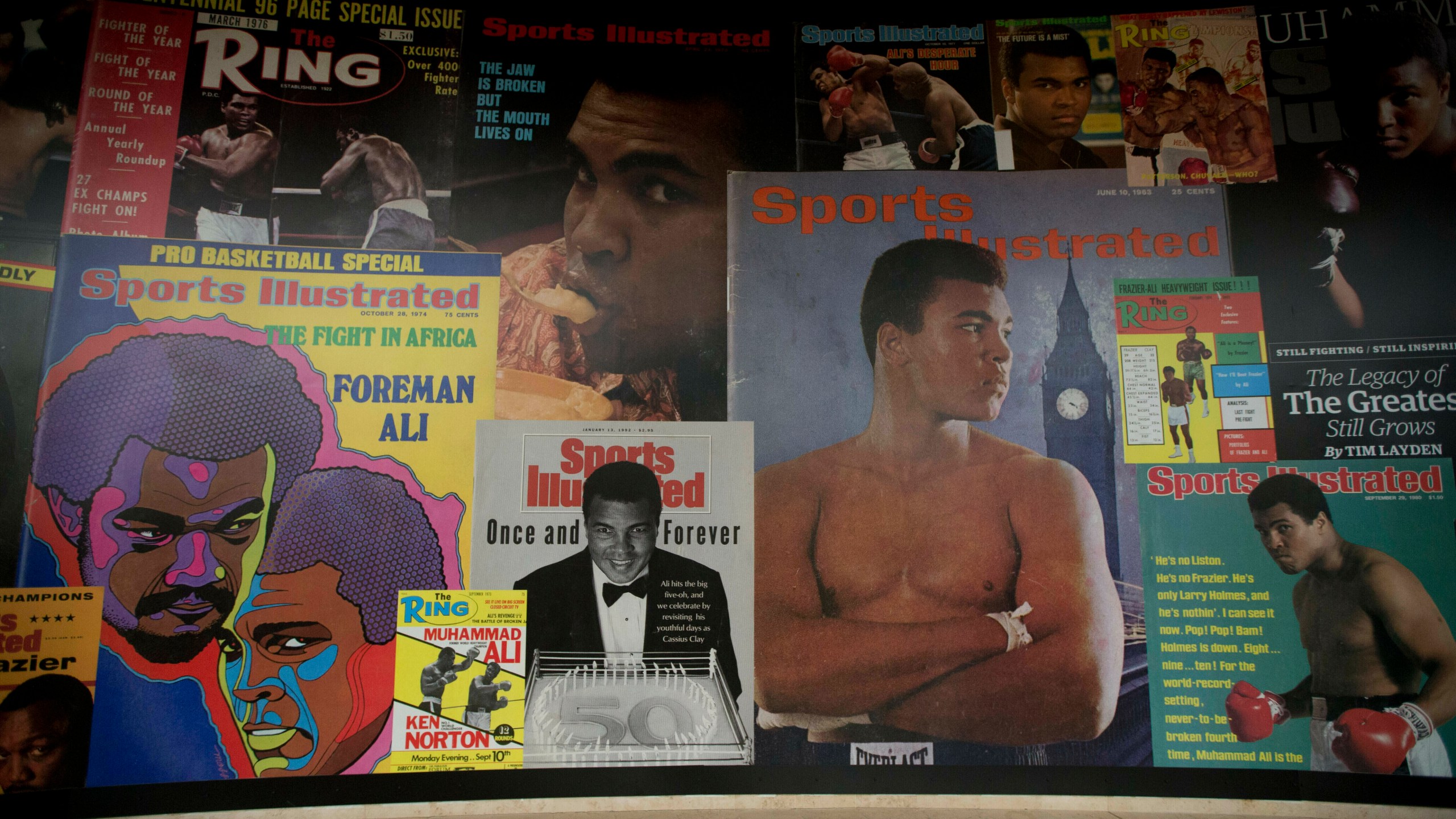 FILE - Large posters of mostly Sports Illustrated magazine covers are displayed at the "I Am The Greatest, Muhammad Ali" exhibition at the O2 arena, which hosts high profile boxing fights in London, June 4, 2016. Sports Illustrated will continue operations after the company that owns the brand reached an agreement with a new publisher for its print and digital products, Monday, March 18, 2024. (AP Photo/Matt Dunham, File)
