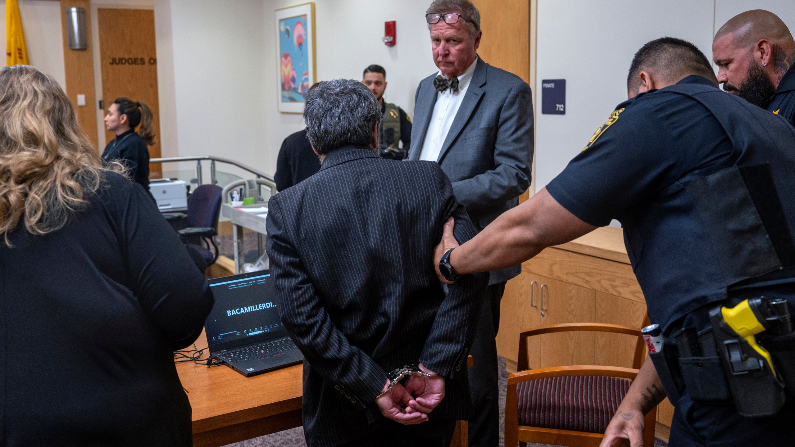 Muhammed Syed, center, with his attorney Thomas Clark, is taken into custody after he was convicted of killing Aftab Hussien in 2022, in Bernalillo County Courthouse in Albuquerque, N.M., Monday, March 18, 2024. (Eddie Moore/The Albuquerque Journal via AP)