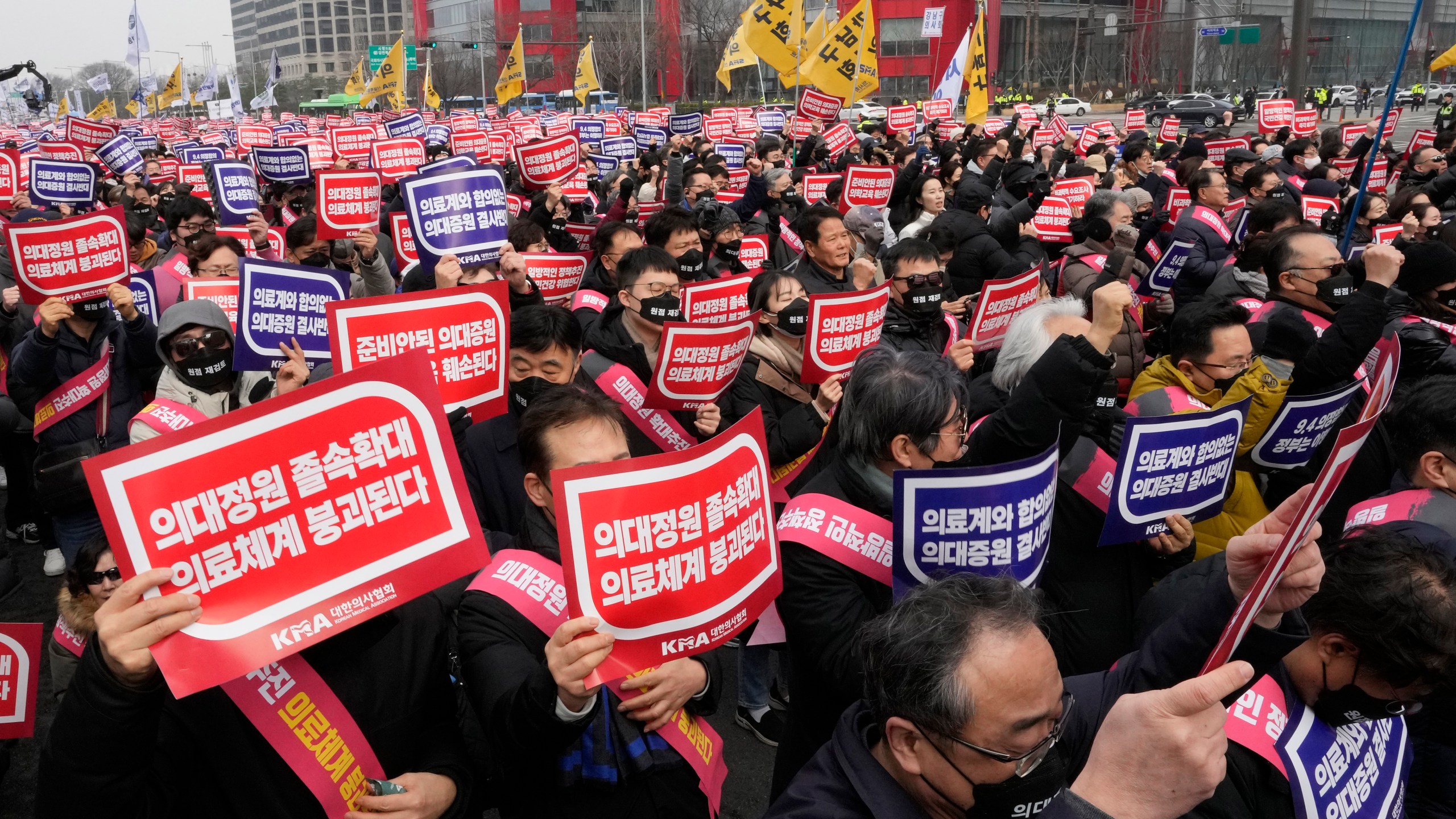 FILE - Doctors stage a rally against the government's medical policy in Seoul, South Korea, on March 3, 2024. South Korean authorities have suspended the licenses of two senior doctors for allegedly inciting the weekslong walkouts by medical interns and residents that disrupted hospital operations across the country. That's according to one of the doctors who spoke to The Associated Press. The suspensions are the government’s first punitive step against physicians after thousands of doctors-in-training walked off the job last month to protest the government’s plan to sharply increase medical school admissions. (AP Photo/Ahn Young-joon, File)