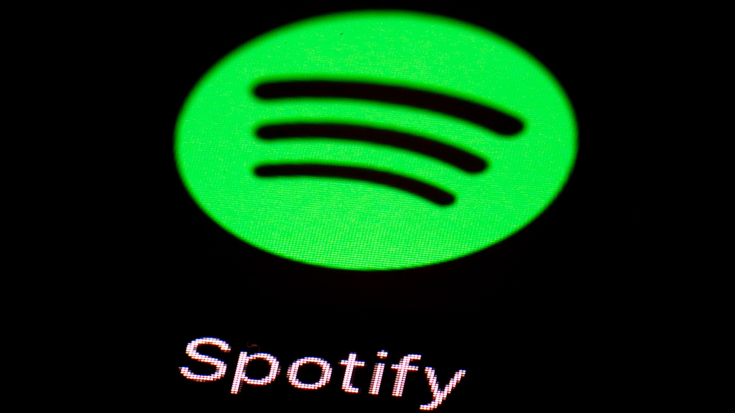 FILE - The Spotify app is displayed on an iPad in Baltimore, March 20, 2018. Since late last century and the early days of the web, providers of digital media like Netflix and Spotify have had a free pass when it comes to international taxes on films, video games and music that are shipped across borders through the internet. But now, a global consensus on the issue may be starting to crack. (AP Photo/Patrick Semansky, File)
