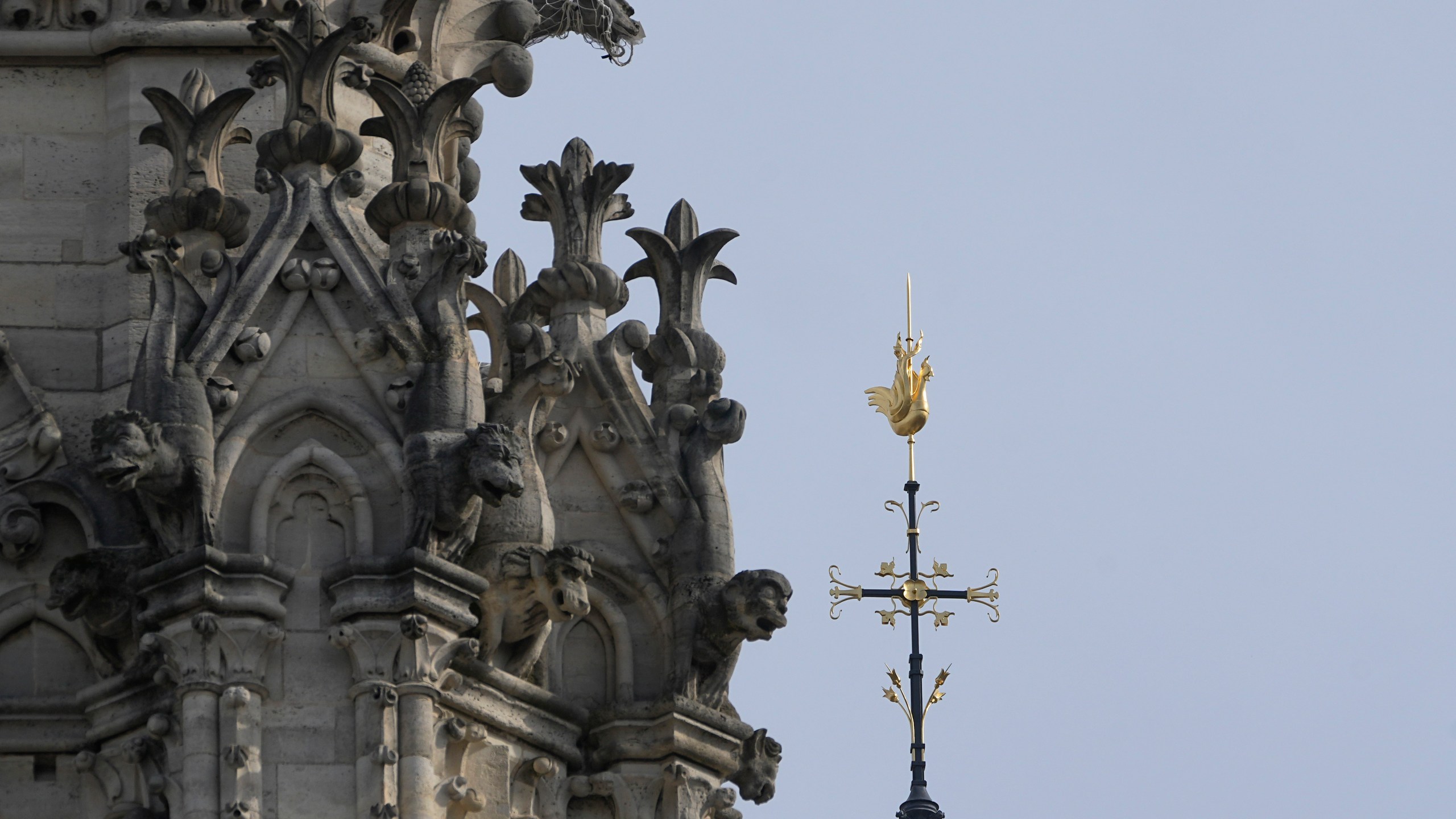 The cross and the rooster atop the Notre Dame de Paris cathedral spire, Thursday, March 14, 2024 in Paris. Scaffolding has enshrouded Notre Dame Cathedral in Paris since a 2019 fire destroyed its spire and roof and threatened to collapse the whole medieval structure. After an unprecedented international reconstruction effort, the scaffolding is at last starting to peel away. (AP Photo/Michel Euler)