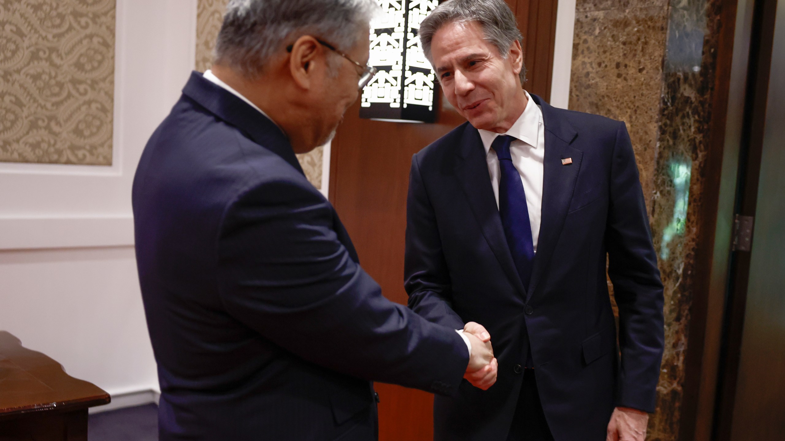 U.S. Secretary of State Antony Blinken, right, shakes hands with Philippines' Secretary of Foreign Affairs Enrique Manalo at the Sofitel Hotel in Manila, Philippines Tuesday, March 19, 2024. (Evelyn Hockstein/Pool Photo via AP)
