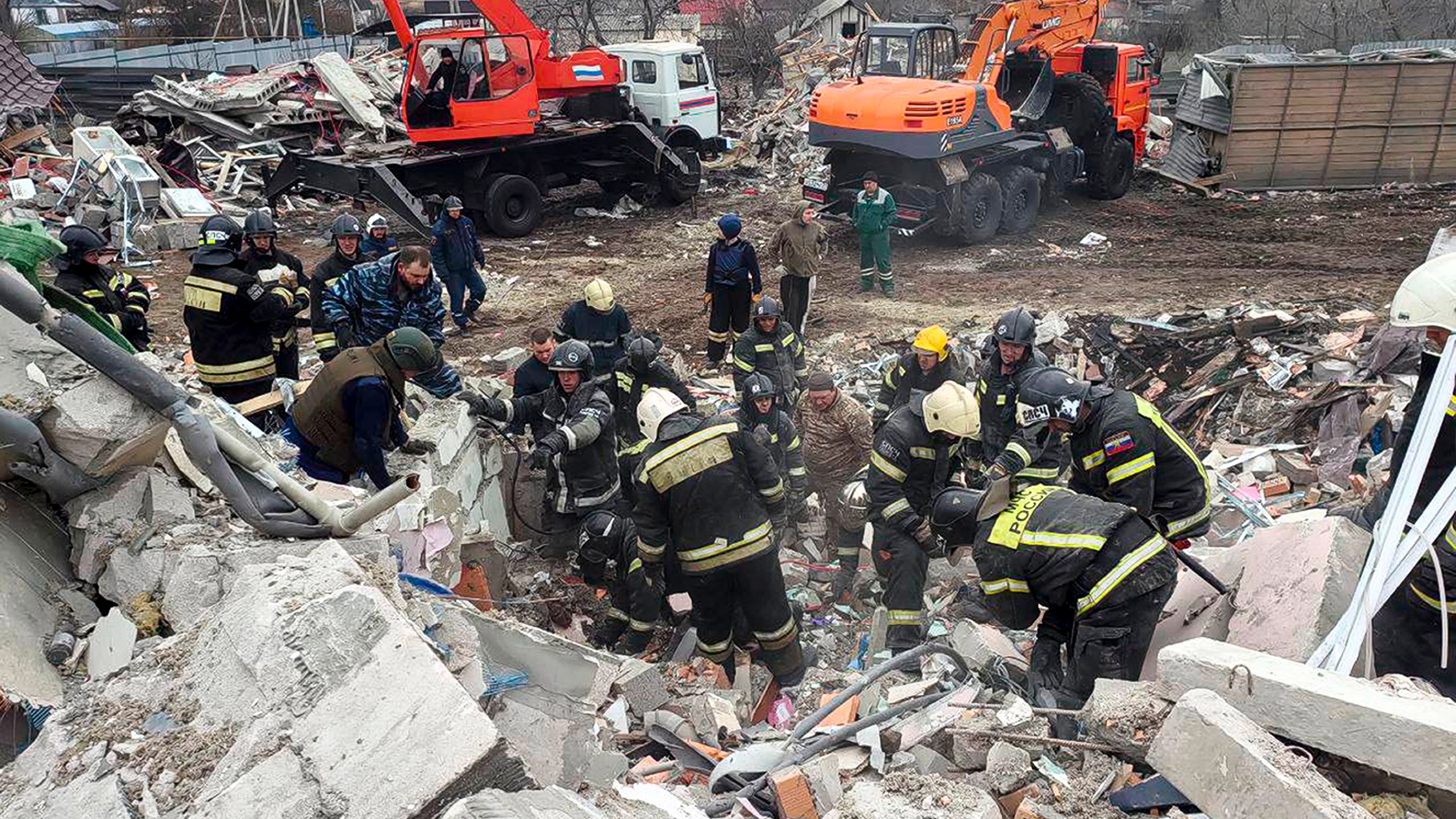 This photo released by Belgorod region governor Vyacheslav Gladkov's telegram channel on Monday, March 18, 2024, shows emergency ministry employees working at the destroyed building after shelling from the Ukrainian side, in Nikolskoye village, Belgorod region, Russia. Belgorod region governor Vyacheslav Gladkov says four people were killed in the shelling, not far from the border with Ukraine. (Belgorod Region Governor Vyacheslav Gladkov telegram channel via AP)