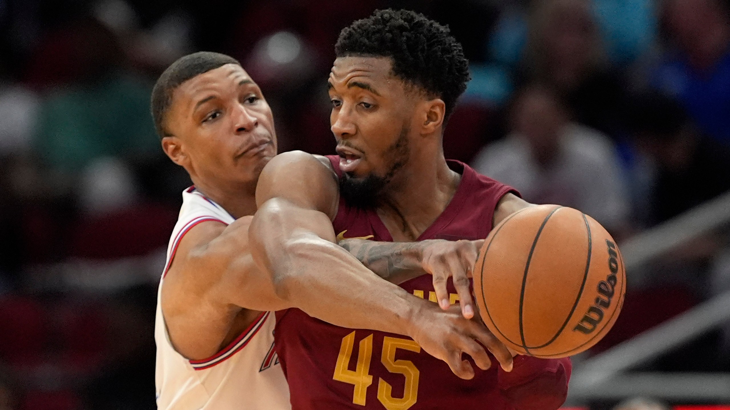 Houston Rockets' Jabari Smith Jr., left, knocks the ball away from Cleveland Cavaliers' Donovan Mitchell (45) during the second half of an NBA basketball game Saturday, March 16, 2024, in Houston. The Rockets won 117-103. (AP Photo/David J. Phillip)