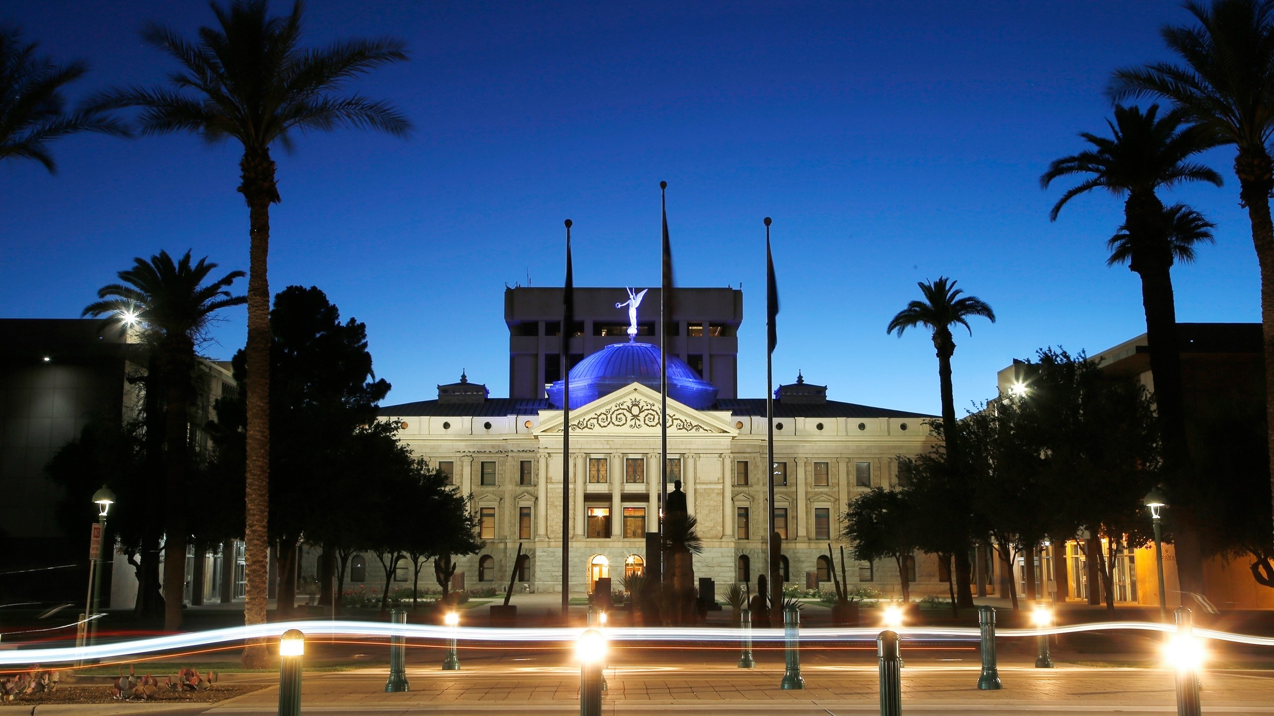 FILE - The blur of car lights zip past the Arizona Capitol as the dome is illuminated on April 15, 2020, in Phoenix. An Arizona lawmaker announced on the state Senate floor Monday, March 18, 2024, that she plans to have an abortion after learning that her pregnancy is not viable. (AP Photo/Ross D. Franklin, File)
