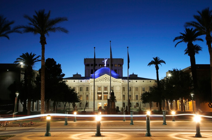 FILE - The blur of car lights zip past the Arizona Capitol as the dome is illuminated on April 15, 2020, in Phoenix. An Arizona lawmaker announced on the state Senate floor Monday, March 18, 2024, that she plans to have an abortion after learning that her pregnancy is not viable. (AP Photo/Ross D. Franklin, File)