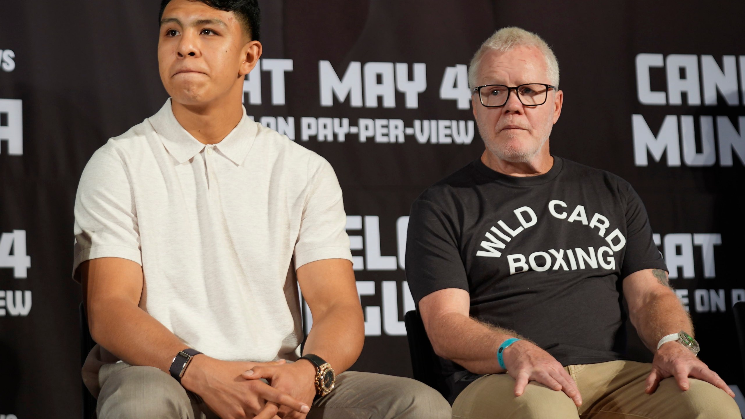 Boxer Jaime Munguía, left, with his trainer Freddie Roach take questions from the media about their upcoming fight with boxer Canelo Alvarez, during a news conference in Beverly Hills, Calif., Tuesday, March 19, 2024. Alvarez will defend his titles against All-Action Star Jaime Munguía on Saturday, May 4, at T-Mobile Area in Las Vegas. (AP Photo/Damian Dovarganes)