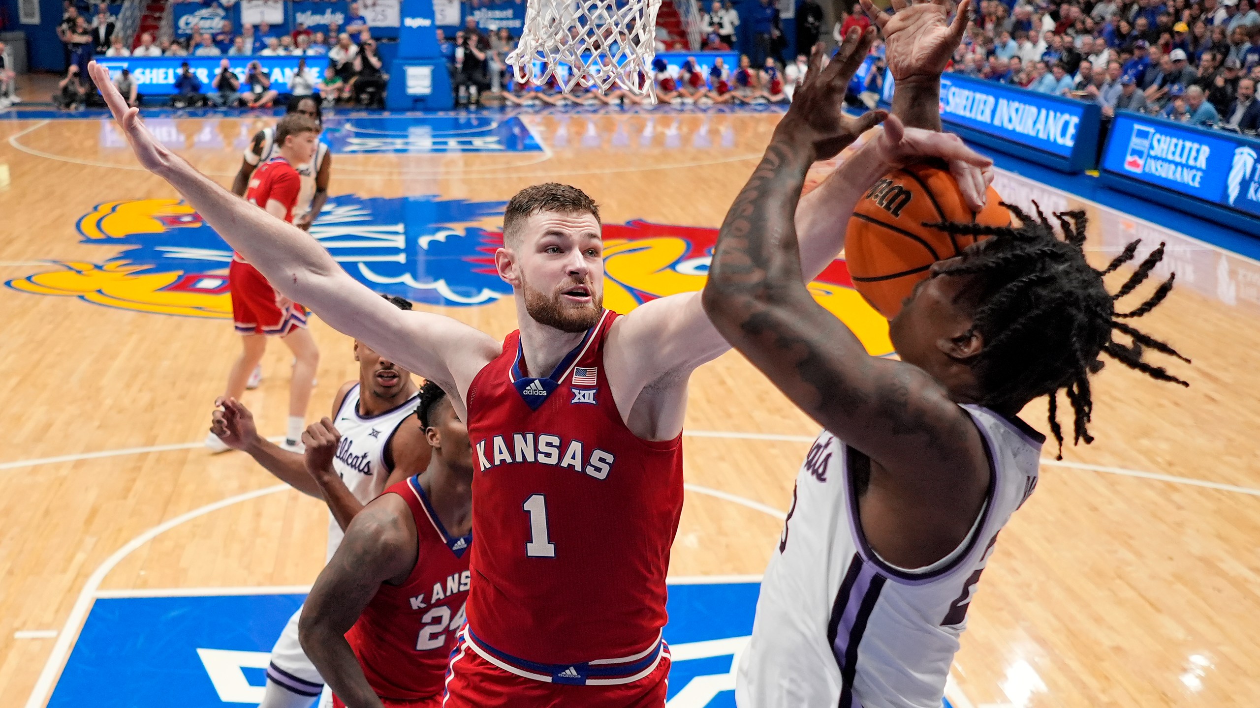 Kansas center Hunter Dickinson (1) knocks the ball away from Kansas State forward Macaleab Rich during the second half of an NCAA college basketball game Tuesday, March 5, 2024, in Lawrence, Kan. Kansas won 90-68. (AP Photo/Charlie Riedel)