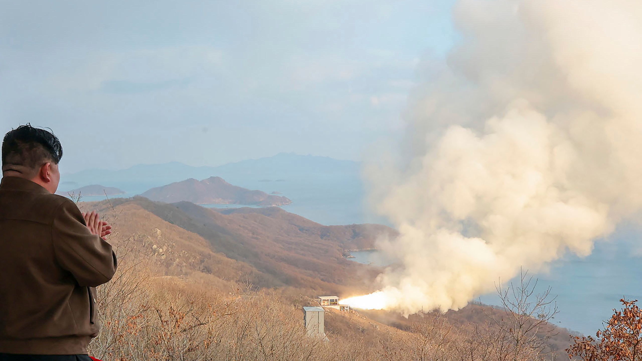 In this photo provided by the North Korean government, North Korean leader Kim Jong Un, left, watches what it says a test of a solid-fuel engine for its new-type intermediate-range hypersonic missile at the Sohae Satellite Launching Ground in North Korea Tuesday, March 19, 2024. Independent journalists were not given access to cover the event depicted in this image distributed by the North Korean government. The content of this image is as provided and cannot be independently verified. (Korean Central News Agency/Korea News Service via AP)
