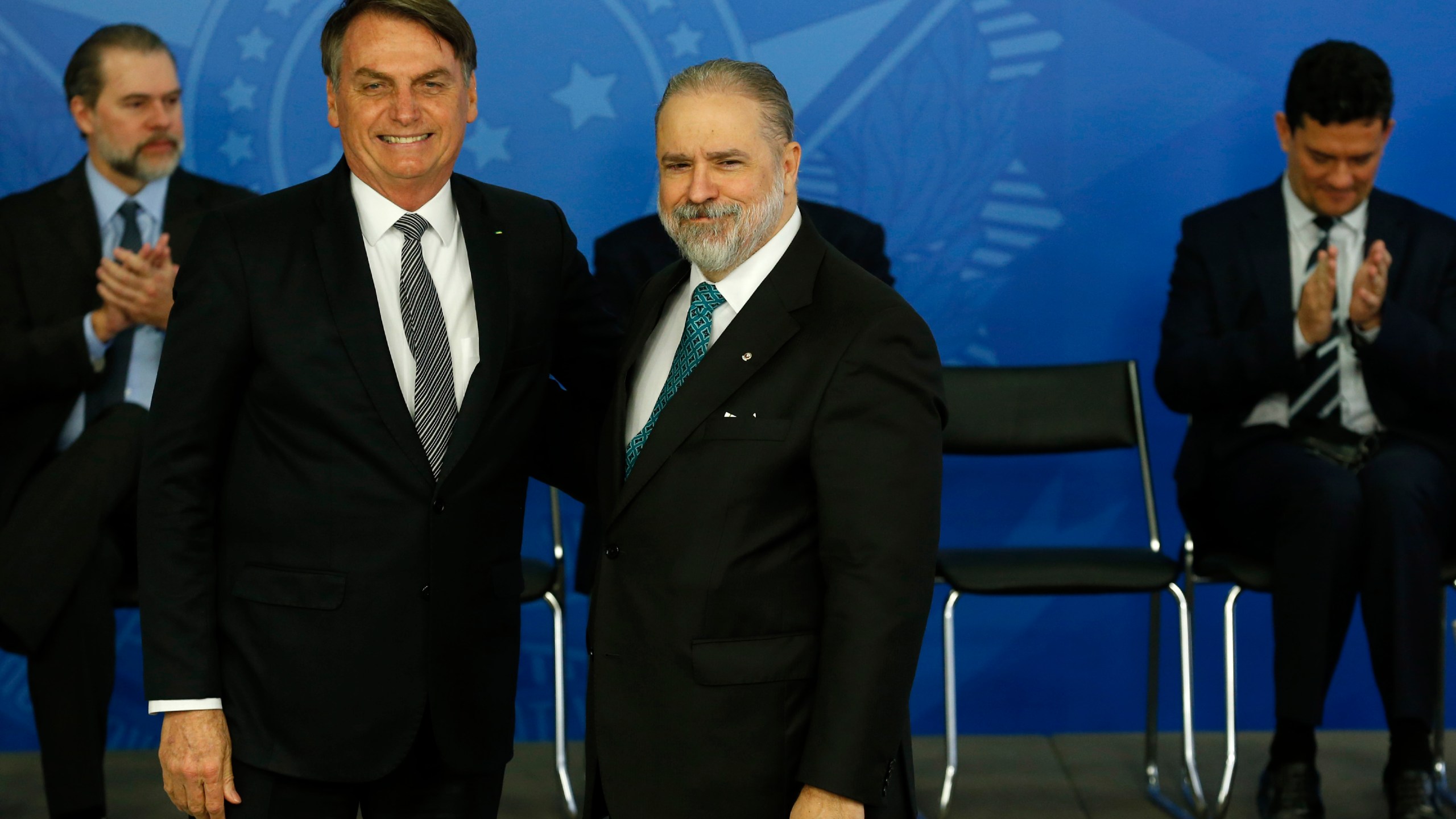 FILE - Brazil's President Jair Bolsonaro poses for a photo with his newly appointed attorney general, Augusto Aras, at the Planalto Presidential Palace, in Brasilia, Brazil, Sept. 26, 2019. A Federal Police indictment unveiled Tuesday, March 19, 2024, has shed new light on a Senate committee inquiry that ended in October 2021 with a recommendation for nine criminal charges against Bolsonaro, alleging that he mismanaged the pandemic. Aras declined to move the case forward. (AP Photo/Eraldo Peres, File)