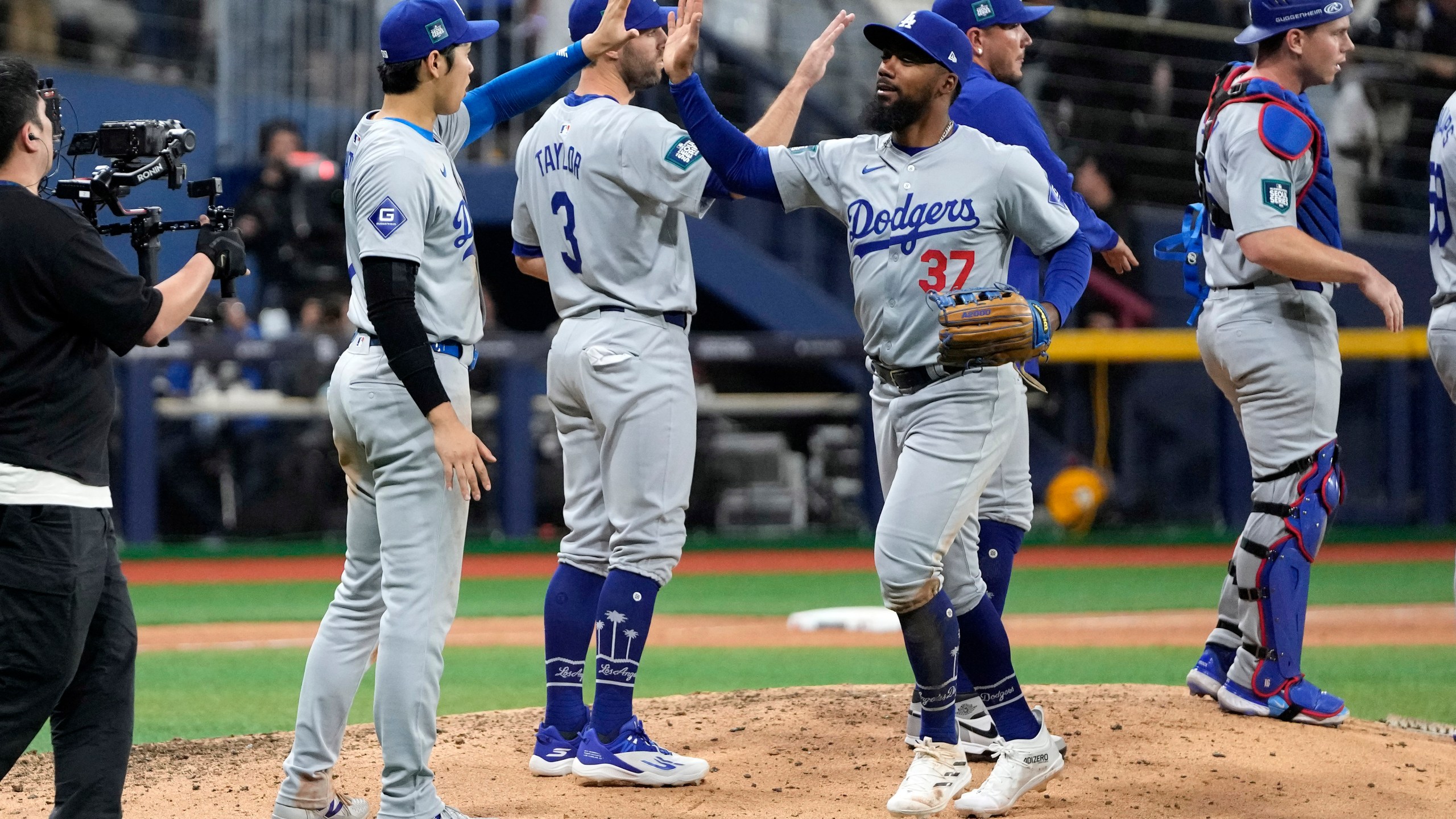 Los Angeles Dodgers designated hitter Shohei Ohtani, second from left, congratulates Teoscar Hernandez after the Dodgers defeated the San Diego Padres 5-2 in an opening day baseball game at the Gocheok Sky Dome in Seoul, South Korea Wednesday, March 20, 2024, in Seoul, South Korea. (AP Photo/Lee Jin-man)