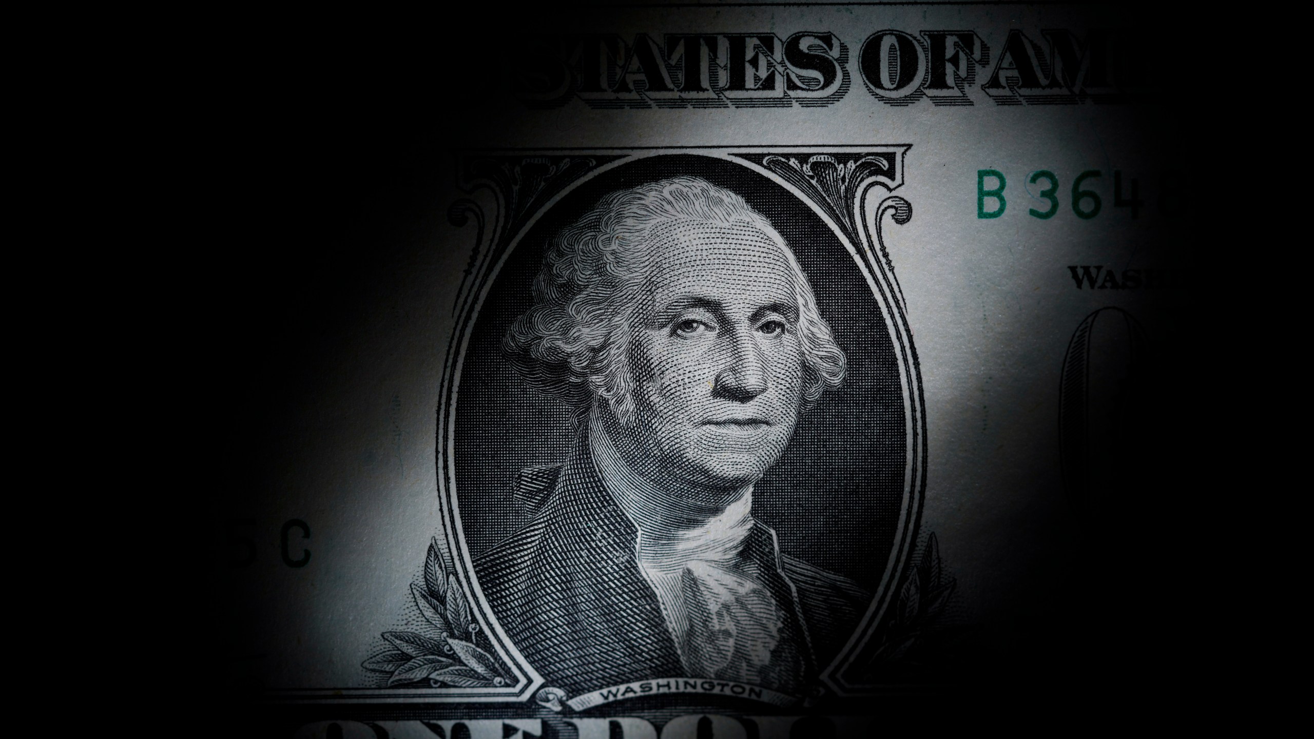 FILE - The likeness of George Washington is seen on a U.S. one dollar bill, March 13, 2023, in Marple Township, Pa. The nonpartisan Congressional Budget Office says it expects the federal government will be awash in debt over the next 30 years. (AP Photo/Matt Slocum, File)