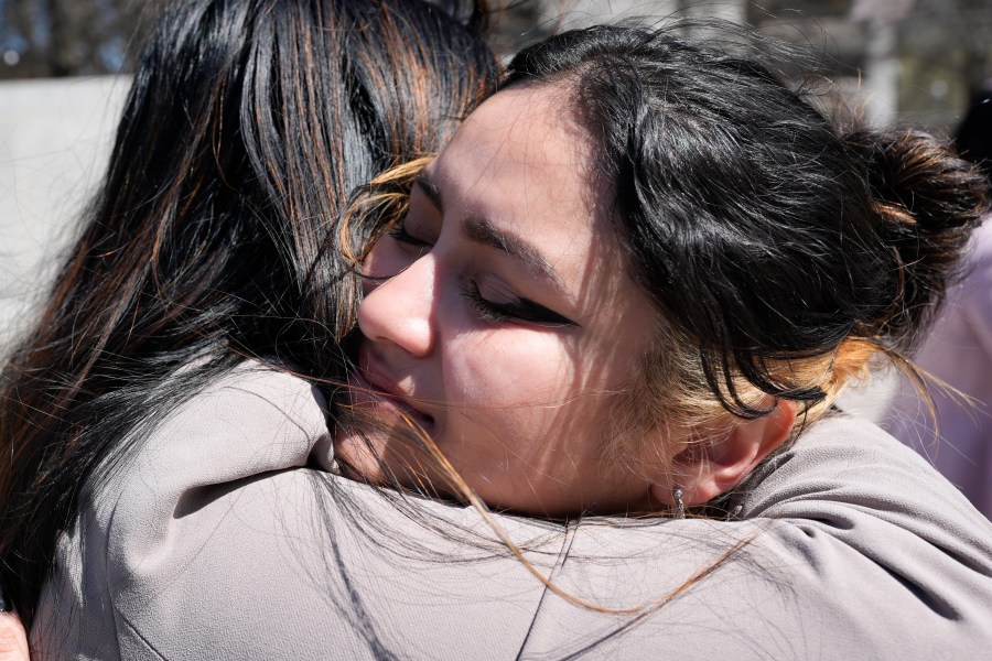 Joanna Maldonado, right, receives a hug after speaking during a news conference of the Tennessee Immigrant and Refugee Rights Coalition outside the state Capitol, Tuesday, March 19, 2024, in Nashville, Tenn. Members of the group came to the state Capitol to lobby legislators to vote against legislation that require local law-enforcement agencies to operate as if they have federal 287(g) agreements and a bill criminalizing transportation of undocumented immigrants. (AP Photo/George Walker IV)