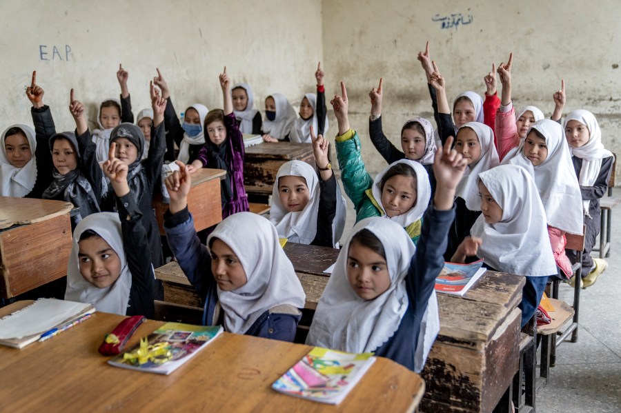 FILE - Afghan school girls attend their classroom on the first day of the new school year, in Kabul, Saturday, March 25, 2023. Afghanistan’s schools open Wednesday for the new educational year, while thousands of schoolgirls remain barred from attending classes for the third year as Taliban banned girls from school beyond sixth grade. The Taliban stopped girls’ education beyond sixth grade because they said it didn’t comply with their interpretation of Islamic law, or Sharia. (AP Photo/Ebrahim Noroozi, File)