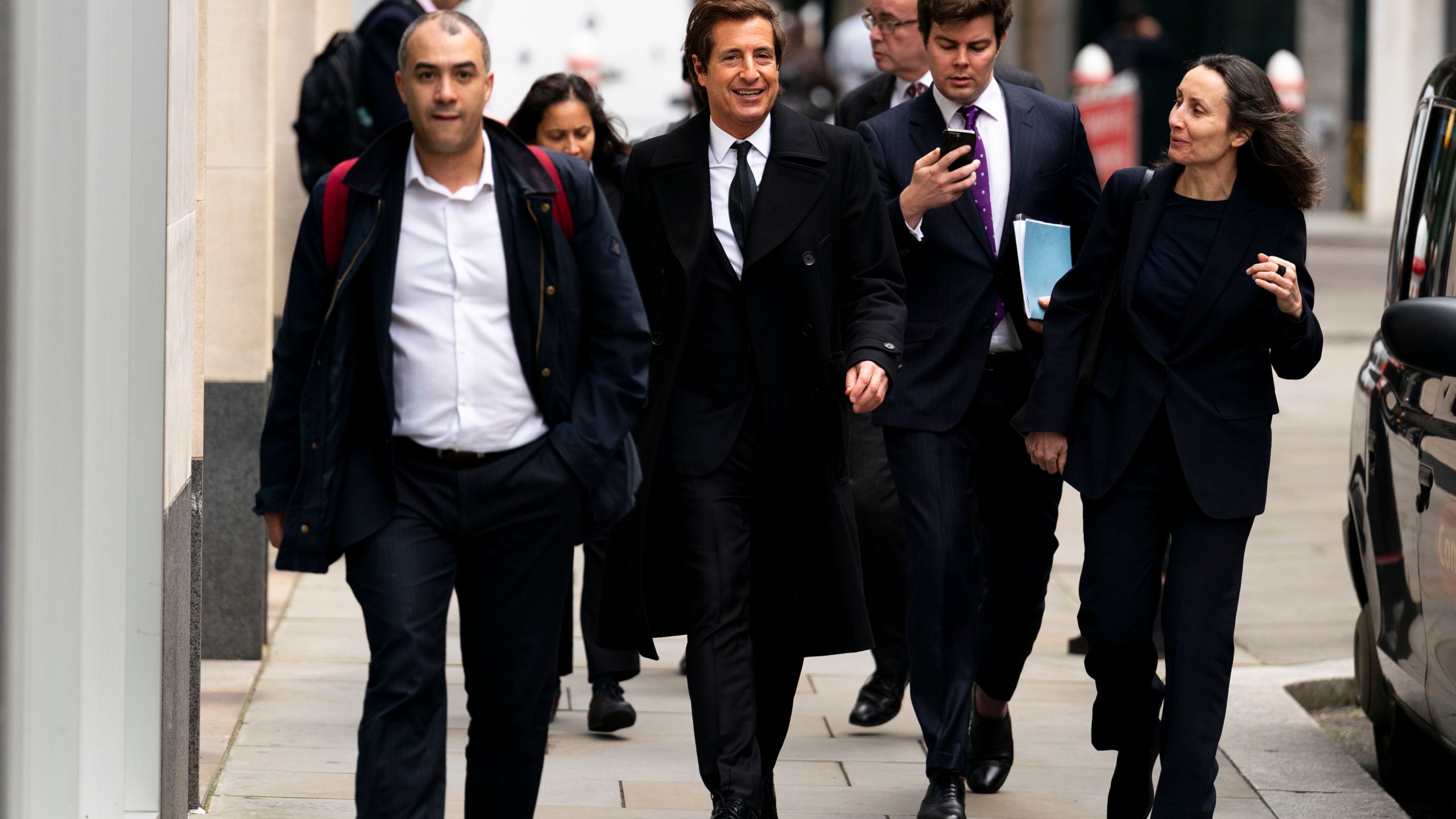 Attorney David Sherborne, second from left, at the Rolls Buildings, central London, Wednesday March 20, 2024. Britain's Prince Harry's lawyer says the cover-up of unlawful information gathering at British tabloids owned by Rupert Murdoch went all the way to the top. Attorney David Sherborne said Wednesday in the High Court that Murdoch was among the executives at News Group Newspapers aware of skullduggery carried out by journalists and private investigators working for the now-defunct News of the World, and The Sun. (Jordan Pettitt/PA via AP)
