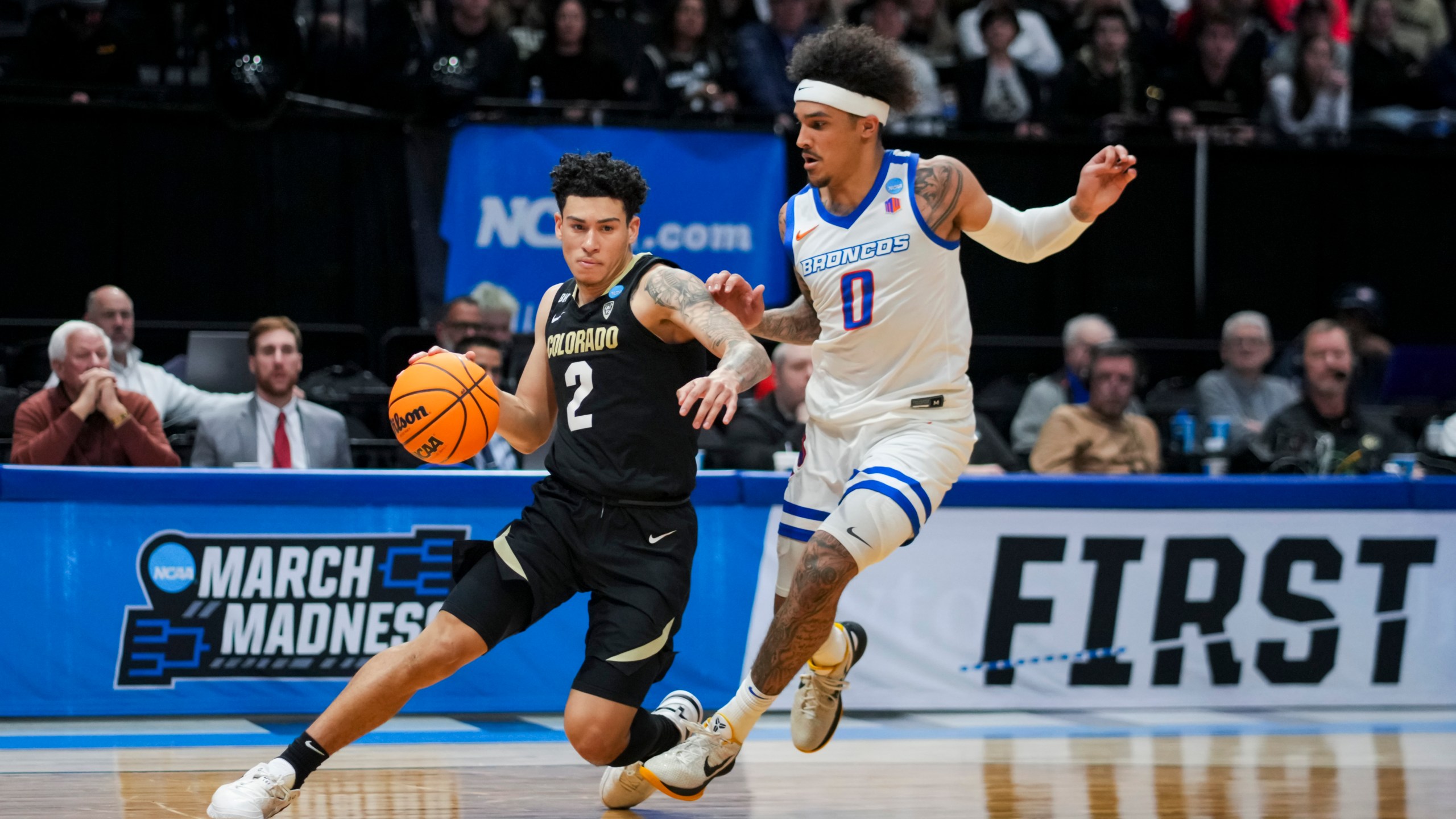 Colorado guard KJ Simpson, left, drives against Boise State guard Roddie Anderson III during the second half of a First Four game in the NCAA men's college basketball tournament Wednesday, March 20, 2024, in Dayton, Ohio. (AP Photo/Aaron Doster)