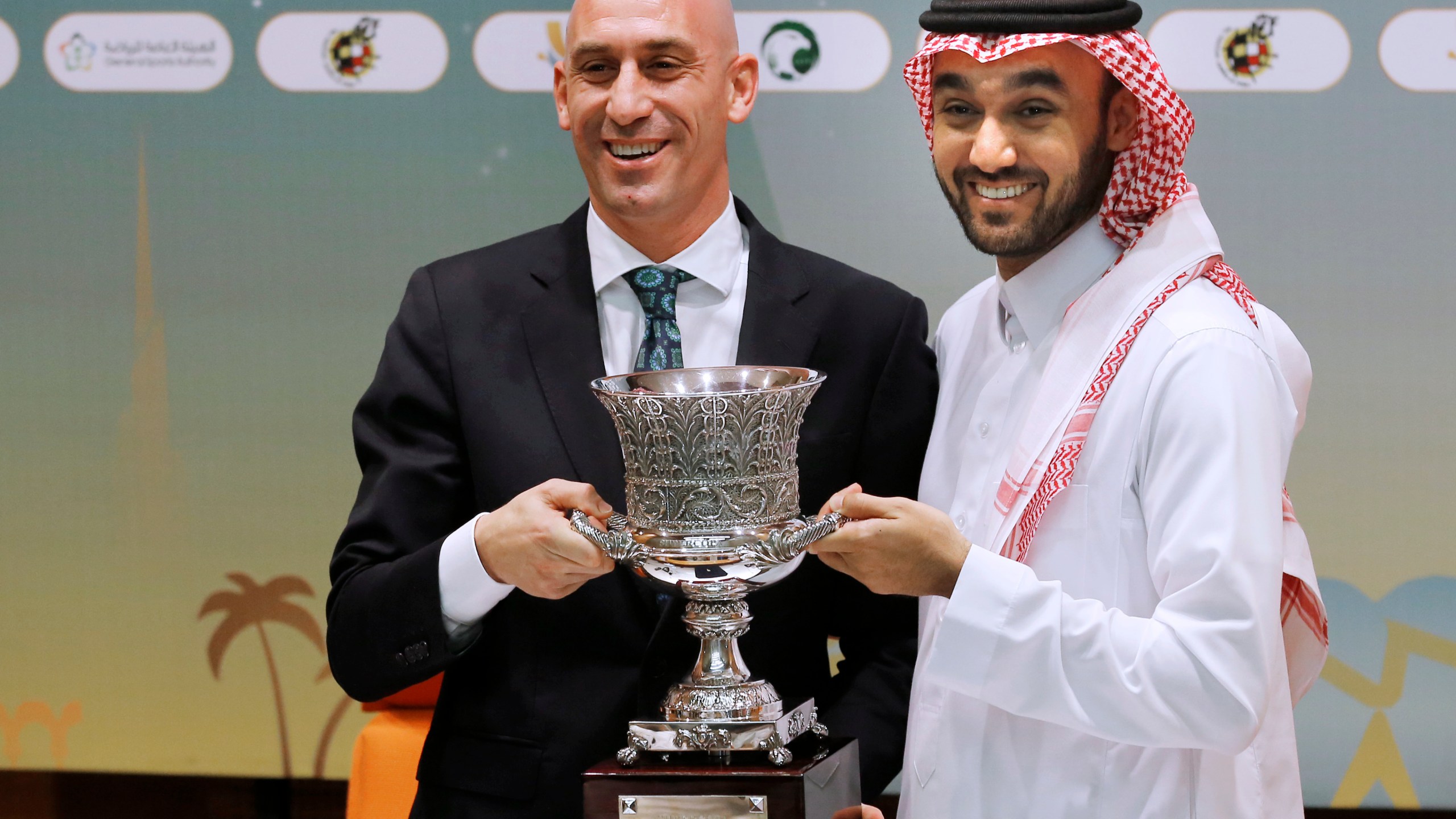 FILE - President of the Spanish Federation, Luis Rubiales, left, and Saudi General Sport Authority GSA chairman Prince Abdulaziz bin Turki Al-Faisal carry the Spanish super cup during a press conference in Jiddah Saudi Arabia, Wednesday, Dec. 18, 2019. Spanish police have arrested at least six people and raided the offices of the Spanish soccer federation as part of a corruption and money laundering investigation that includes suspicions regarding the federation’s deal with Saudi Arabia to take the Spanish Super Cup to the Middle Eastern country. Spain’s Guardia Civil said that they raided the federation’s offices near Madrid and a residence belonging to former federation president Luis Rubiales in the southern city of Granada. Police said that Rubiales was not among the six arrested. (AP Photo/Amr Nabil, File)
