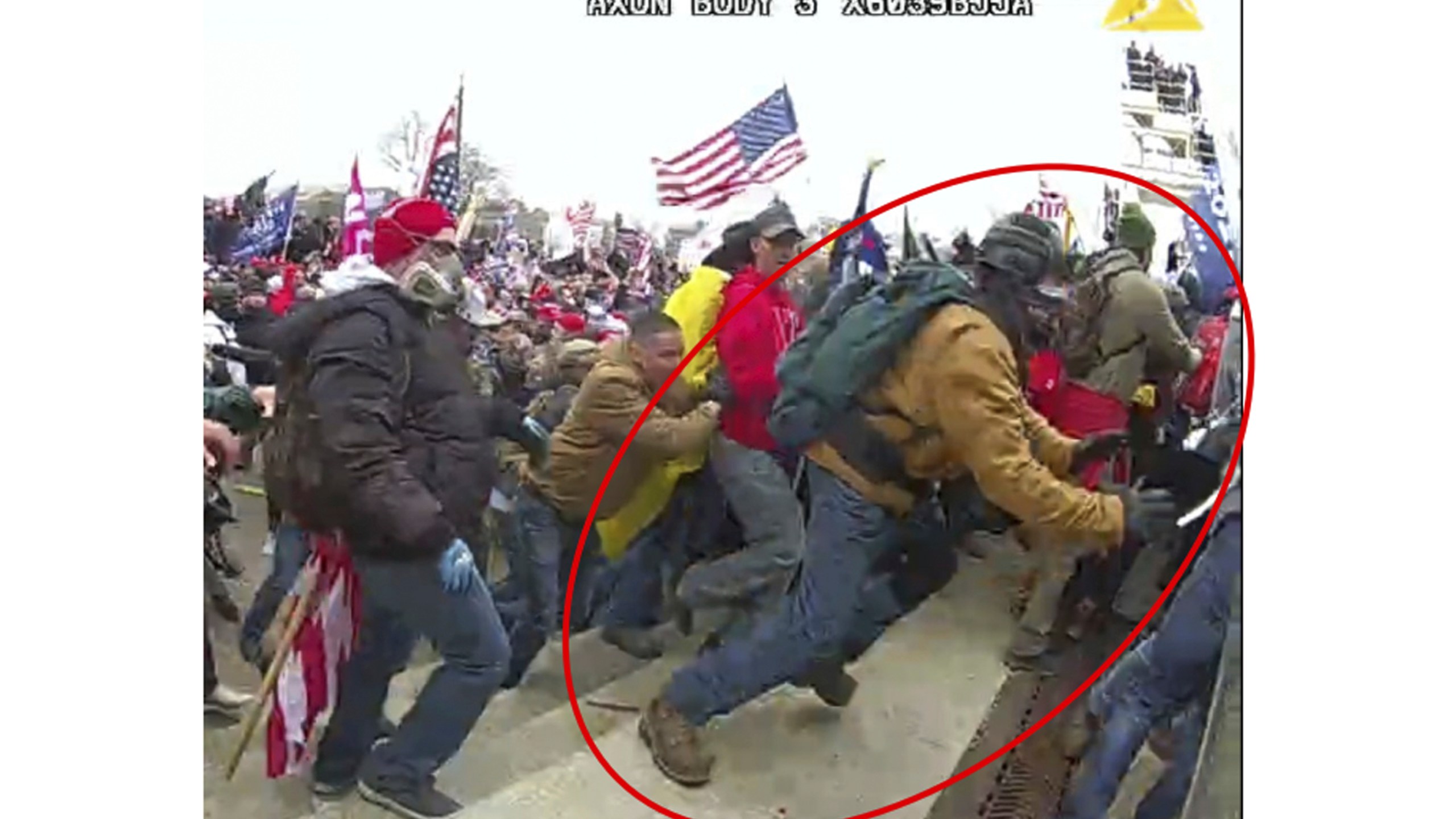 This image from police body-worn camera video, contained and annotated in the Justice Department's government's sentencing memorandum supporting the sentencing of Jeffrey Sabol shows Sabol at the U.S. Capitol on Jan. 6, 2021, in Washington. During the course of an attack on police officers, Sabol ripped the baton out of the hands of a fallen officer, leaving him unable to defend himself against assaults by other rioters. Sabol then helped his co-defendants drag a second officer into the crowd, where that officer was also beaten by rioters. (Department of Justice via AP)