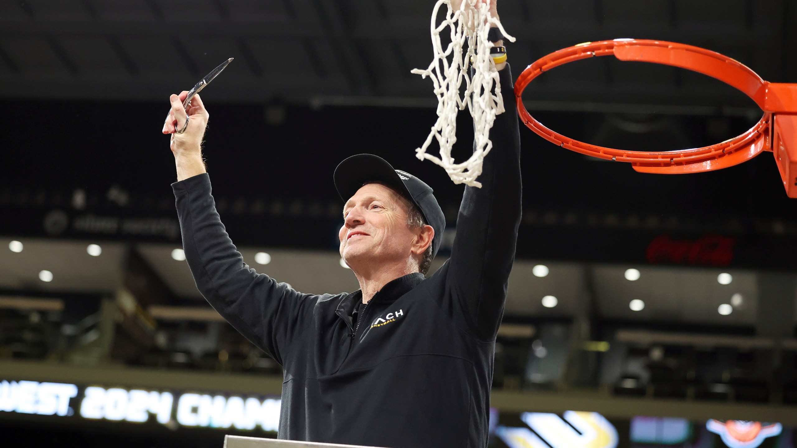Long Beach State head coach Dan Monson participates in a net cutting ceremony after his team played an NCAA college basketball game against UC Davis in the championship of the Big West Conference men's tournament Saturday, March 16, 2024, in Henderson, Nev. Long Beach State won 74-70. (AP Photo/Ronda Churchill)