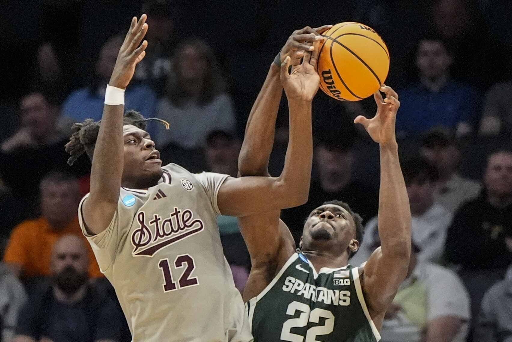 Mississippi State forward KeShawn Murphy (12) and Michigan State center Mady Sissoko (22) vie for a rebound during the first half of a first-round college basketball game in that NCAA Tournament, Thursday, March 21, 2024, in Charlotte, N.C. (AP Photo/Mike Stewart)