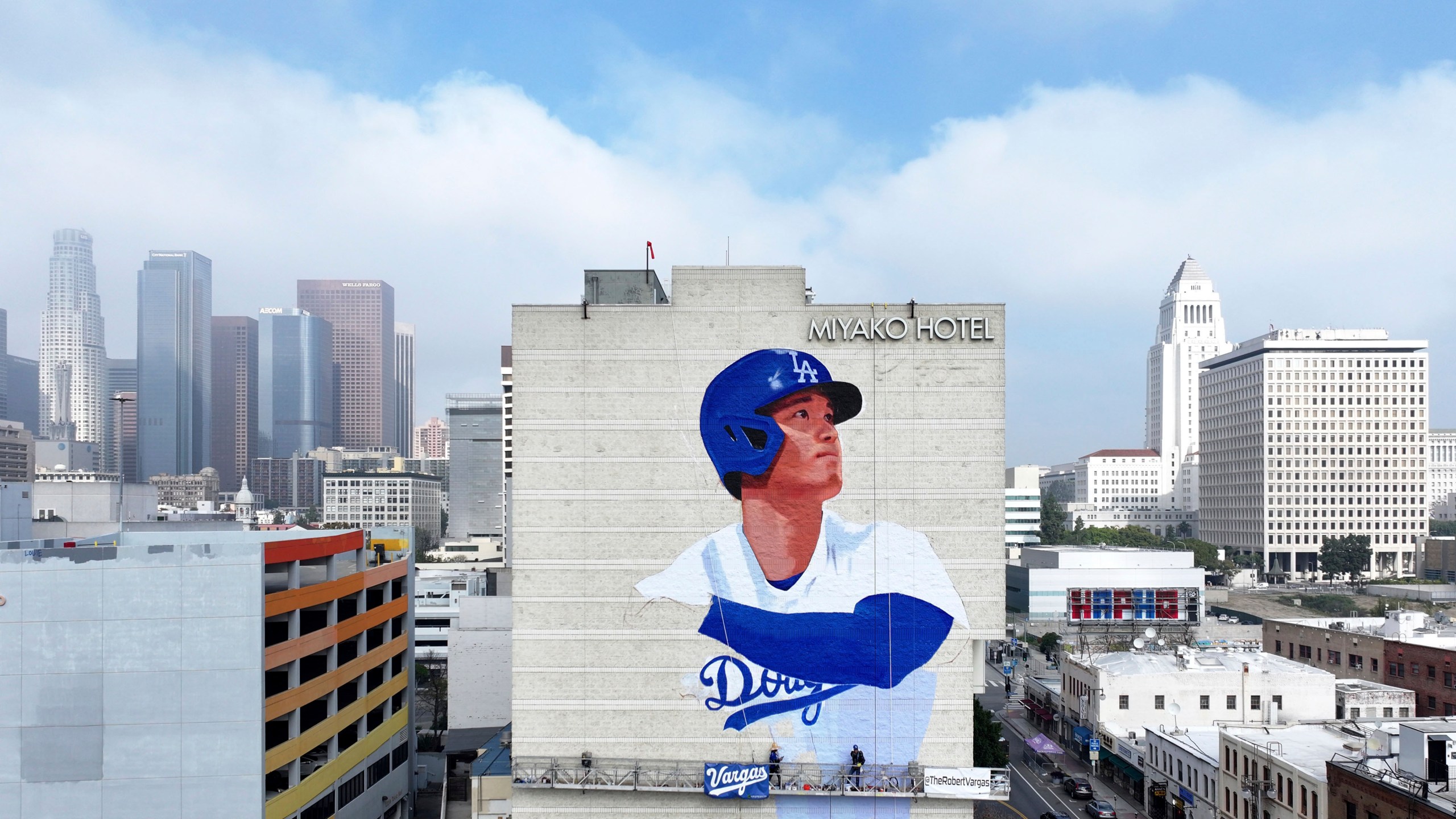 Muralist Robert Vargas, center, works on a new Los Angeles Dodgers baseball player Shohei Ohtani mural titled "L.A. Rising," Wednesday, March 20, 2024, on the Miyako Hotel in the Little Tokyo area of Los Angeles. (Dean Musgrove/The Orange County Register via AP)