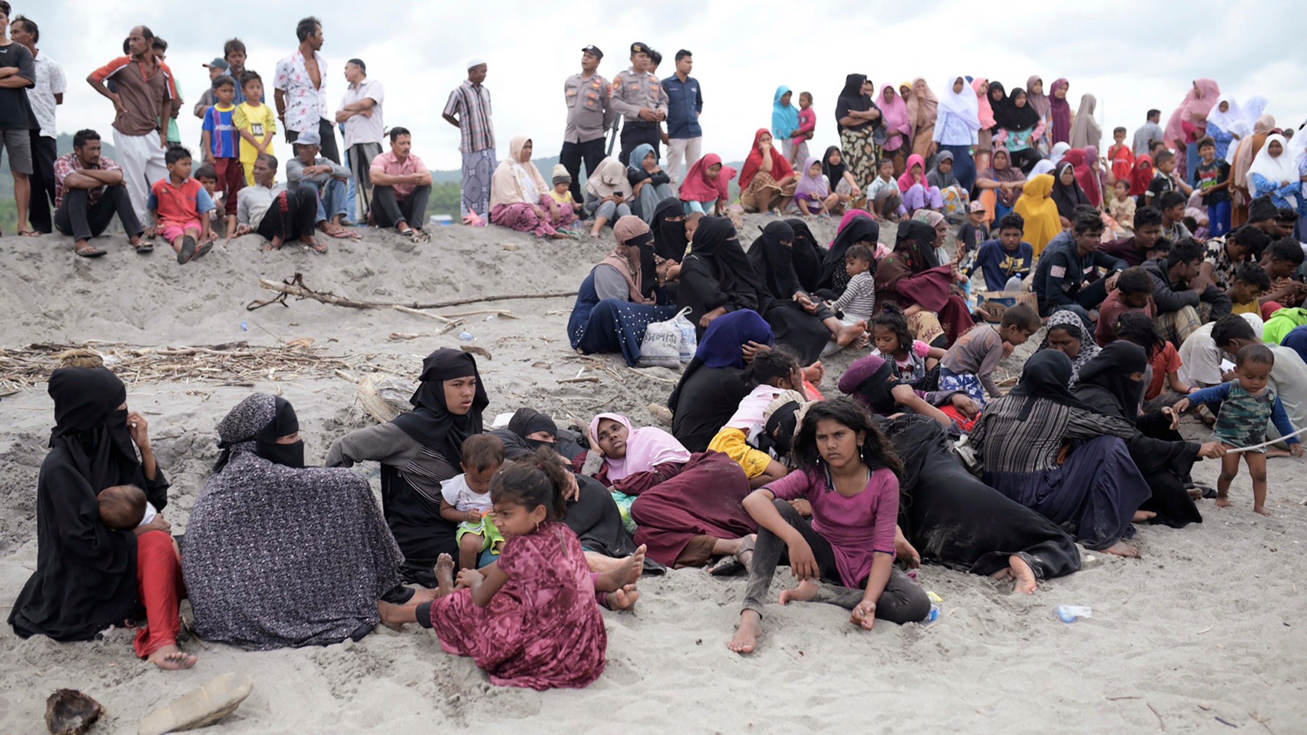 FILE - Ethic Rohingya people rest on Lampanah Leungah beach after landing in Aceh Besar, Aceh province, Indonesia, on Feb. 16, 2023. A dramatic story of survival and rescue off the western coast of Indonesia’s Aceh province has put the spotlight again on the plight of ethnic Rohingya Muslim refugees from Myanmar who make extremely dangerous voyages across the Indian Ocean to seek better lives. (AP Photo/Riska Munawarah, File)