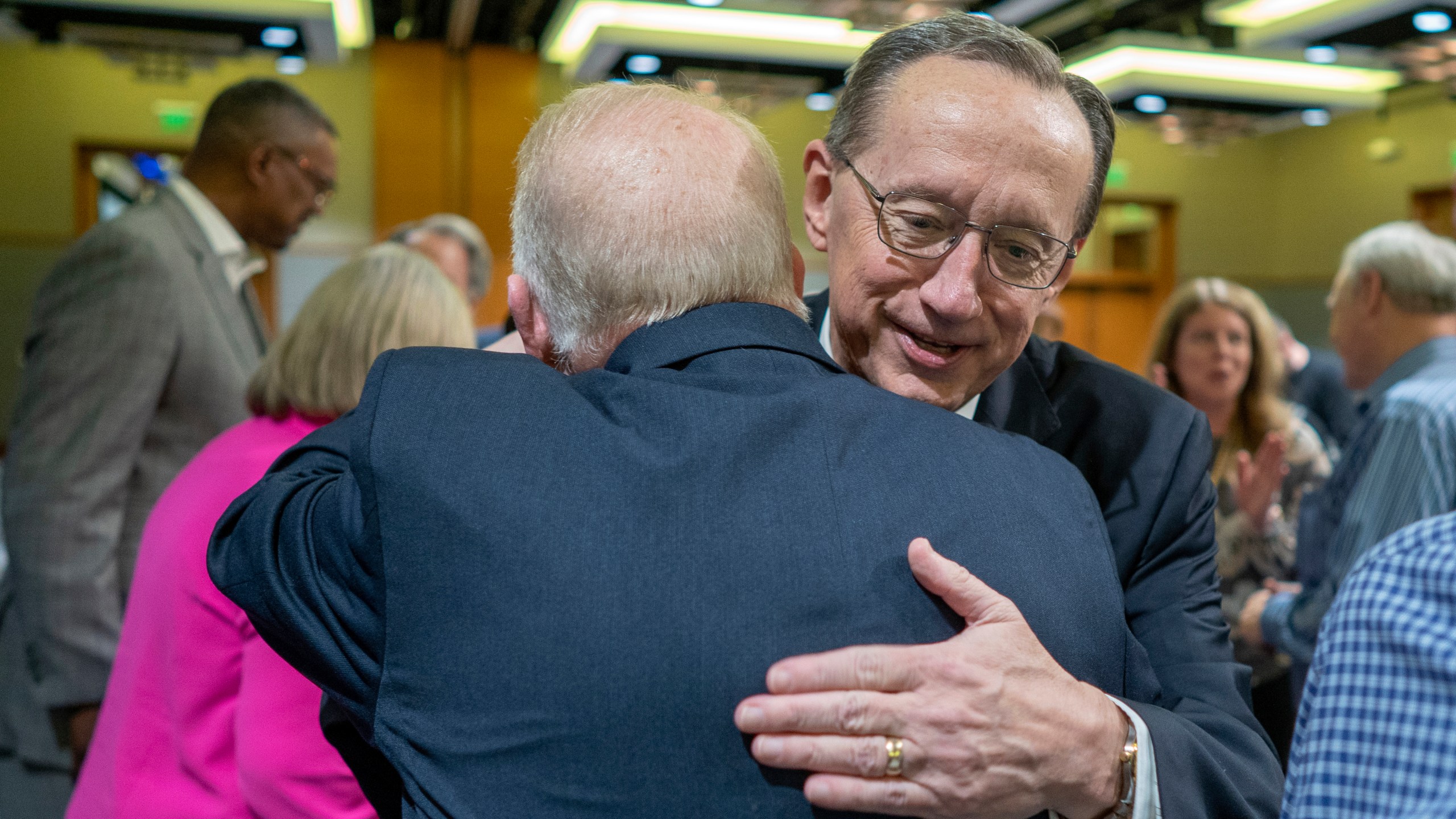 Jeff Iorg, right, hugs presidential search team chair Neal Hughes, Thursday, March 21, 2024, in Dallas, Texas, after Iorg was named the next president and CEO of the Southern Baptist Convention's Executive Committee. (Adam Covington/Baptist Press via AP)
