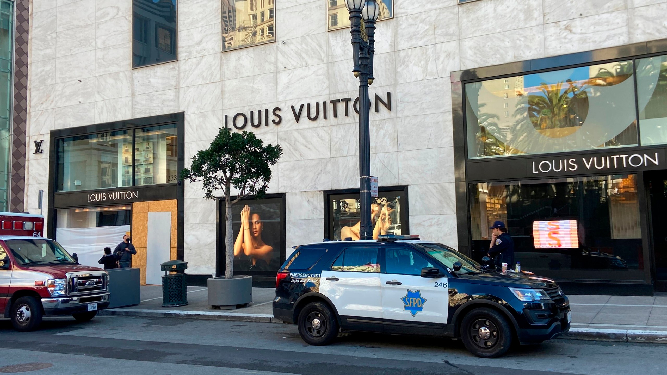 FILE - Police officers and emergency crews park outside the Louis Vuitton store in San Francisco's Union Square on Nov. 21, 2021, after looters ransacked businesses. Facing mounting pressure to crack down on a retail theft crisis, California lawmakers are split on how best to tackle the problem that some say had caused major store closures and products like deodorants to be locked behind plexiglass. (Danielle Echeverria/San Francisco Chronicle via AP, File)