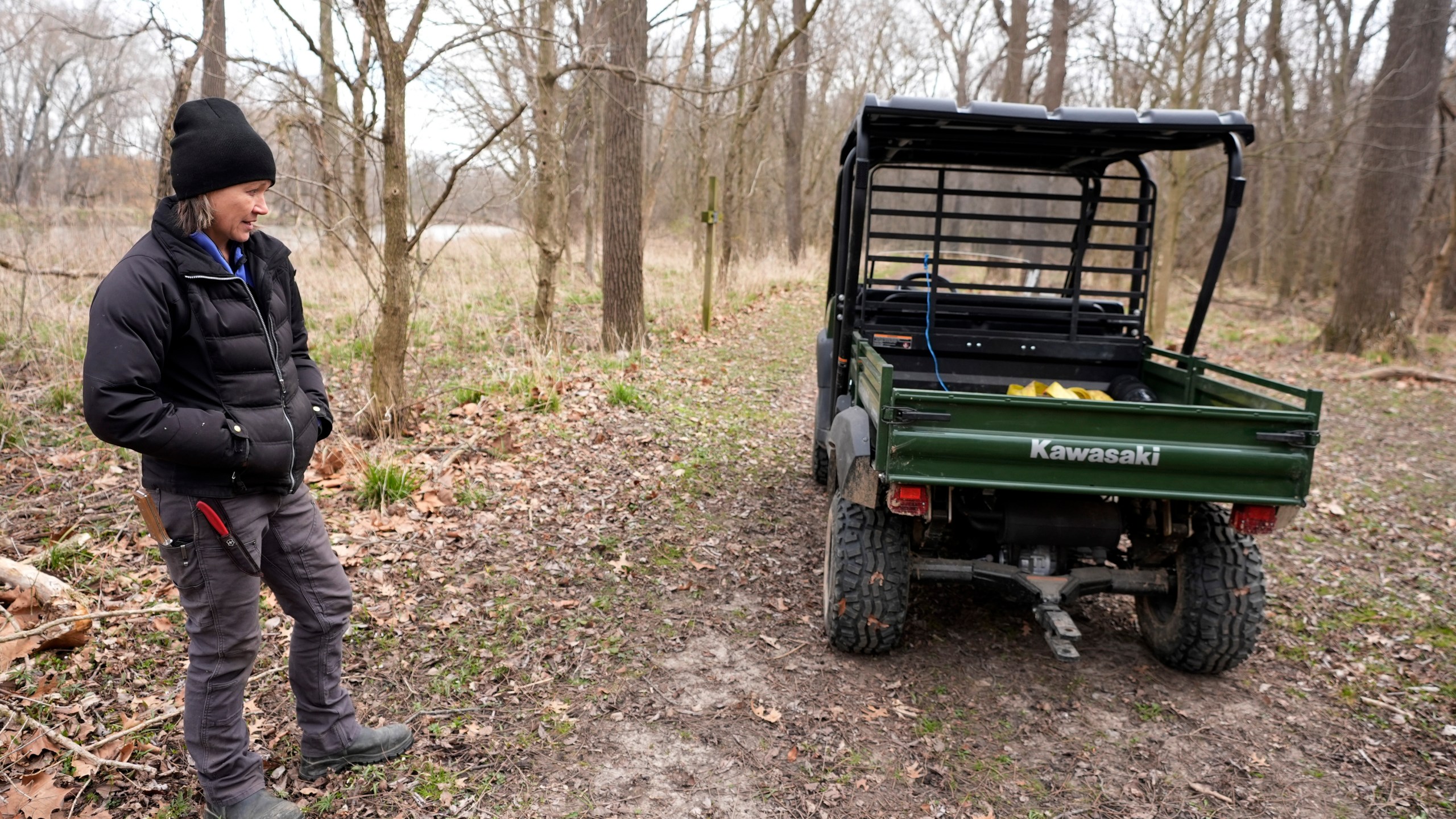 Katy Rogers, the farm manager at Teter Organic Farm and Retreat Center, stands by one of the public hiking trails at the facility, Thursday, March 21, 2024, in Noblesville, Ind. Rogers said in many cases it’s a misconception that organic farmers are harboring massive pest infestations. (AP Photo/Darron Cummings)