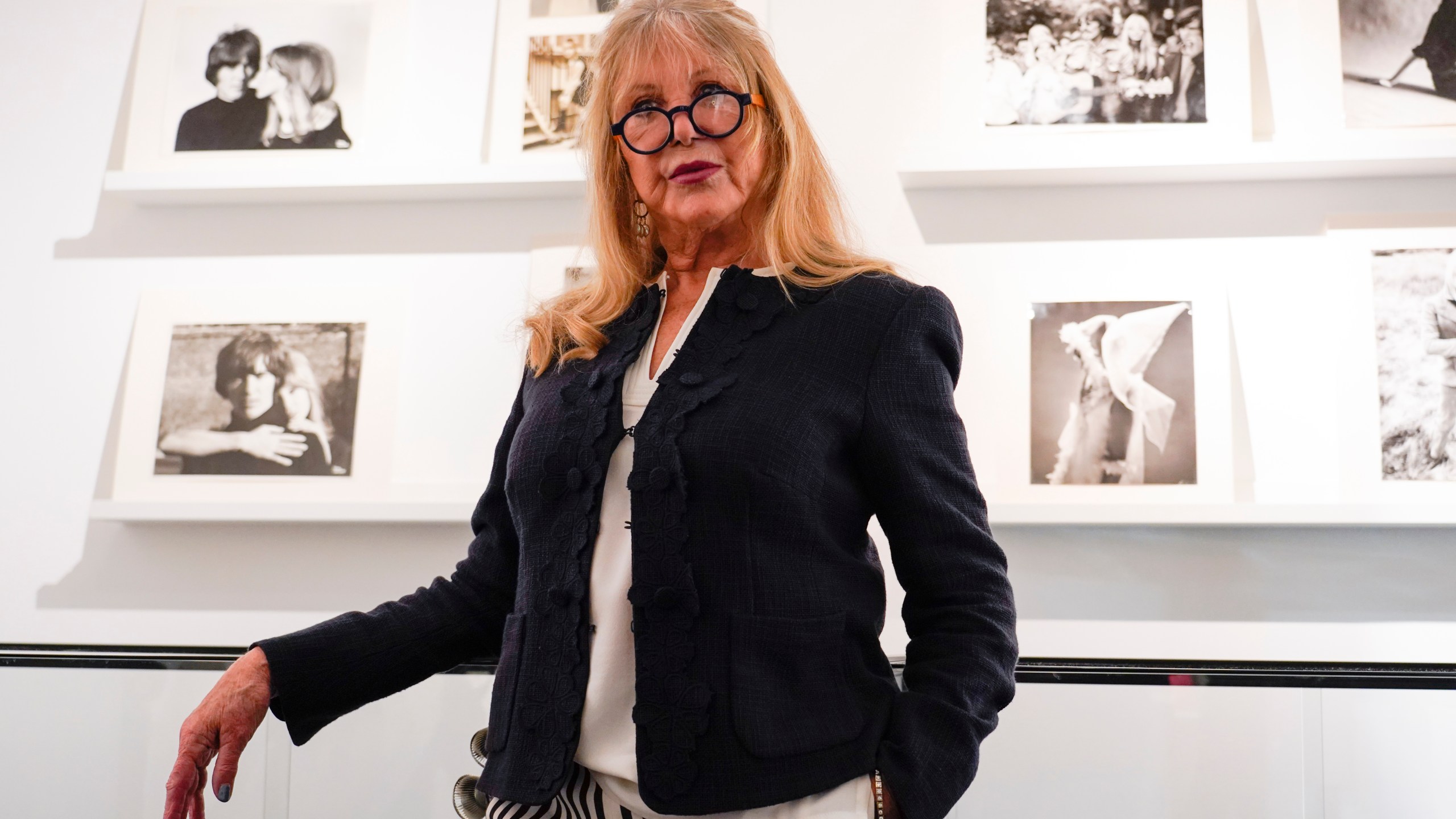 Pattie Boyd next to a set of photographs from The Pattie Boyd Collection, at Christie's, in London, Thursday, March 14, 2024. (AP Photo/Alberto Pezzali)