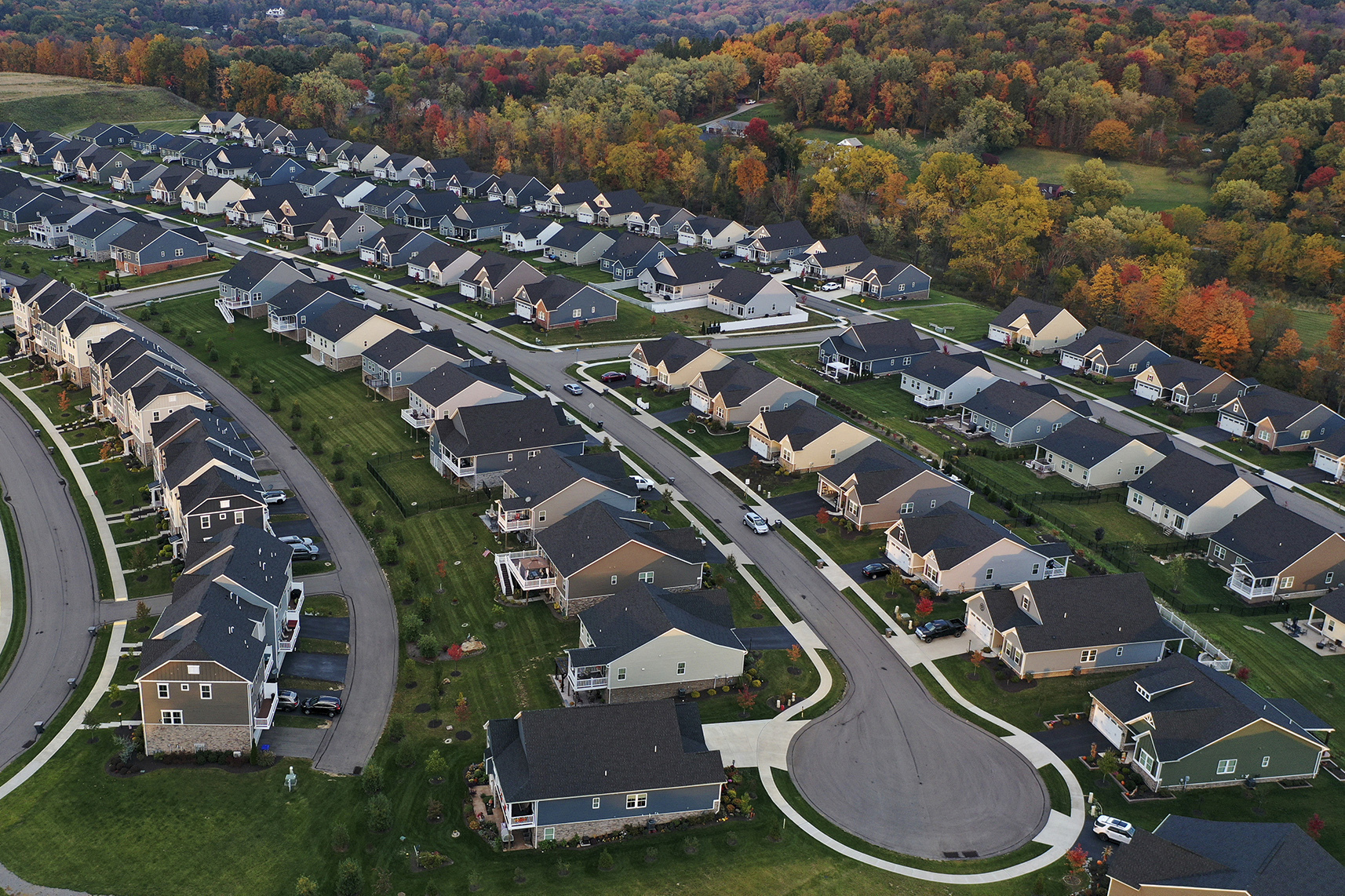 FILE - A new housing development is seen from above, Oct. 12, 2022, in Middlesex Township, Pa. Real estate brokerage company Compass Inc. will pay $57.5 million as part of a proposed settlement to resolve lawsuits over real estate commissions, the company said in a regulatory filing Friday, March 22, 2024. (AP Photo/Gene J. Puskar, File)