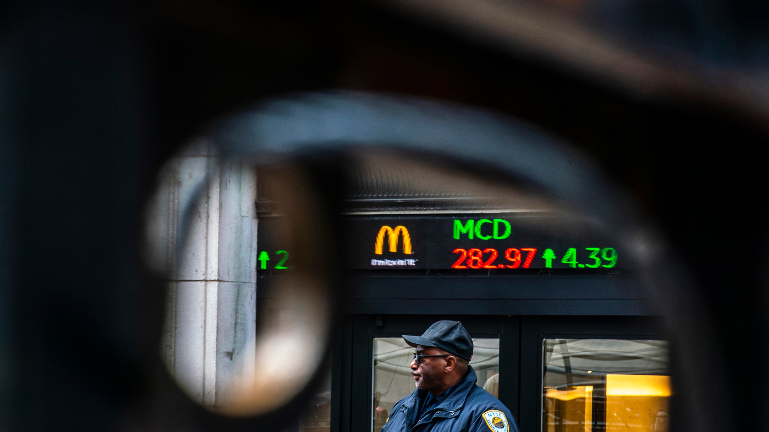 A Security member stands guard at one of the entrance of the New York Stock Exchange in New York, Tuesday, March 19, 2024. (AP Photo/Eduardo Munoz Alvarez)