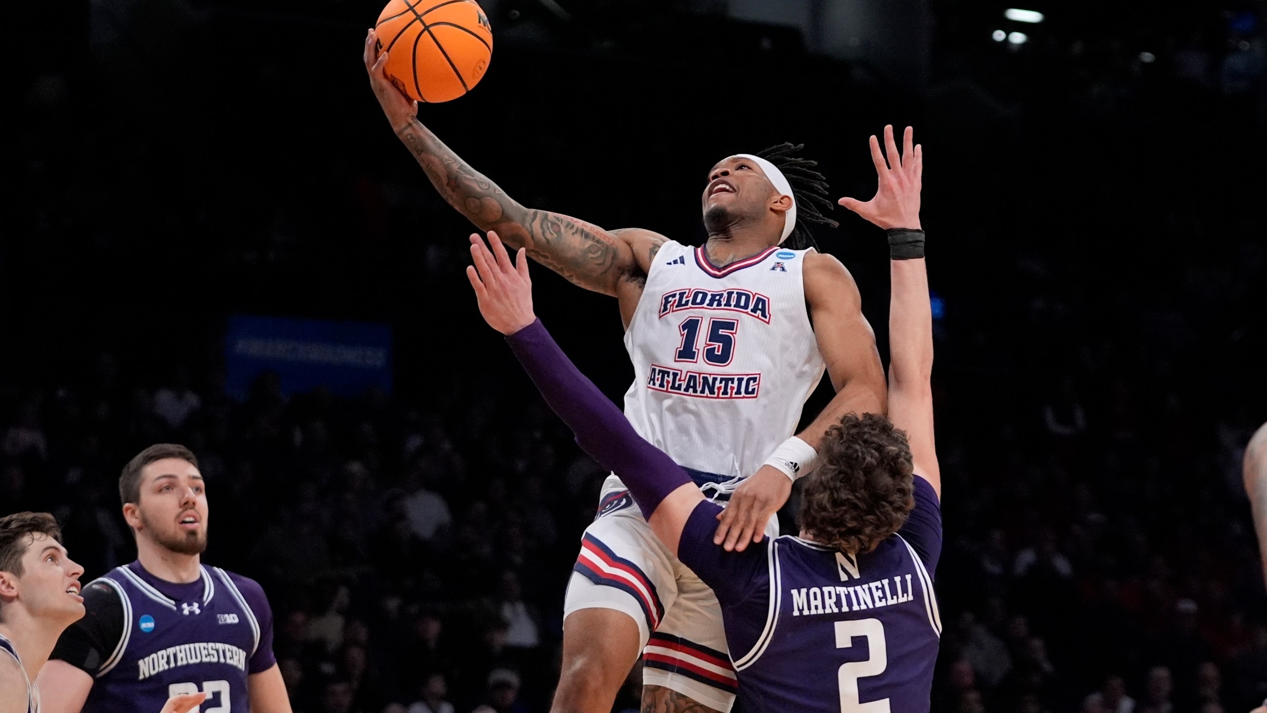Florida Atlantic's Alijah Martin (15) drives past Northwestern's Nick Martinelli (2) during the first half of a first-round college basketball game in the NCAA Tournament, Friday, March 22, 2024, in New York. (AP Photo/Frank Franklin II)