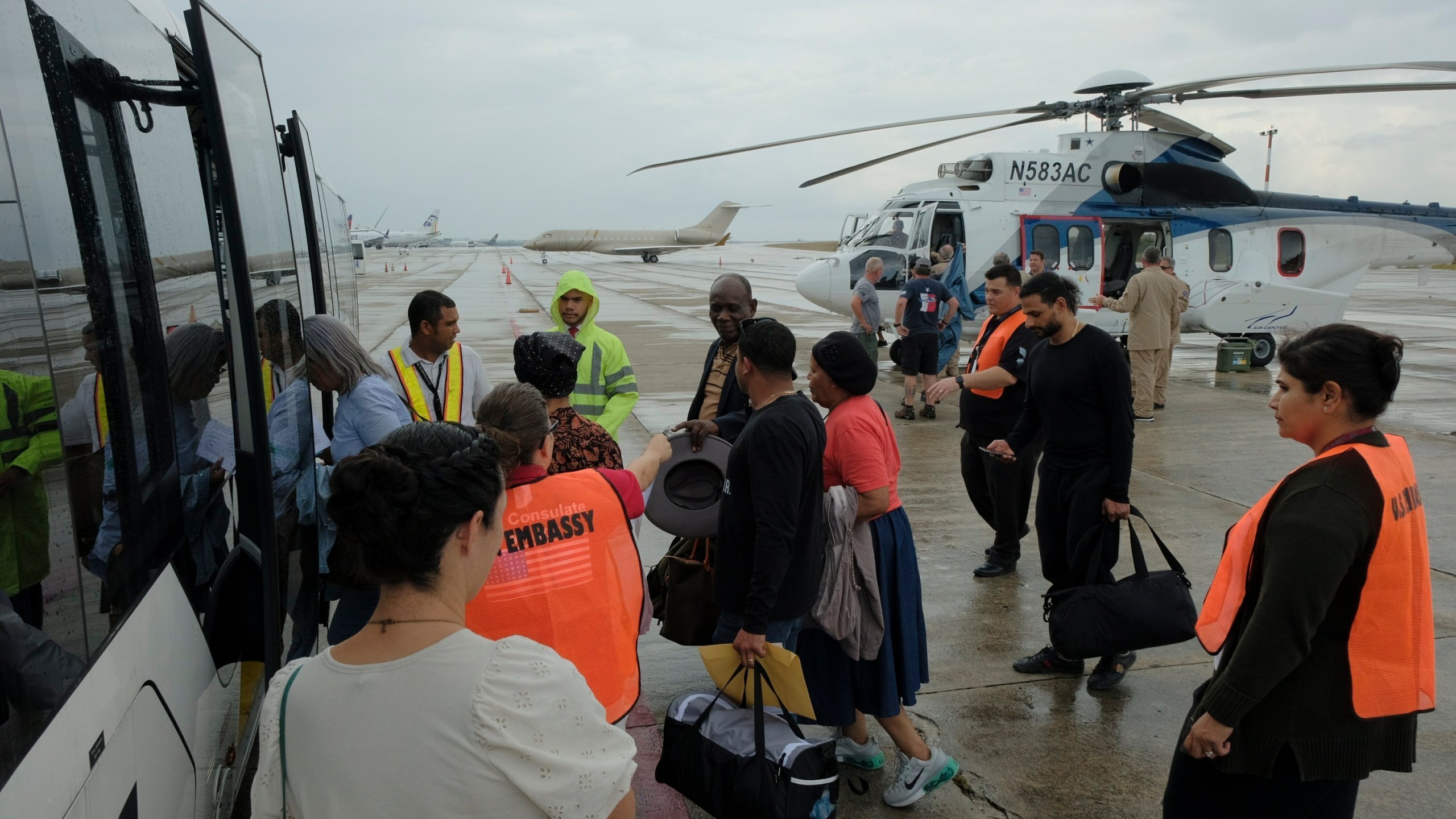 People evacuated in a helicopter from Haiti by the United States arrive at Las Americas airport in Santo Domingo, Dominican Republic, Friday, March 22, 2024. More than 33,000 people have fled Haiti’s capital in nearly two weeks amid gang violence, according to a new report from the U.N.’s International Organization for Migration. (AP Photo/Ricardo Hernandez)