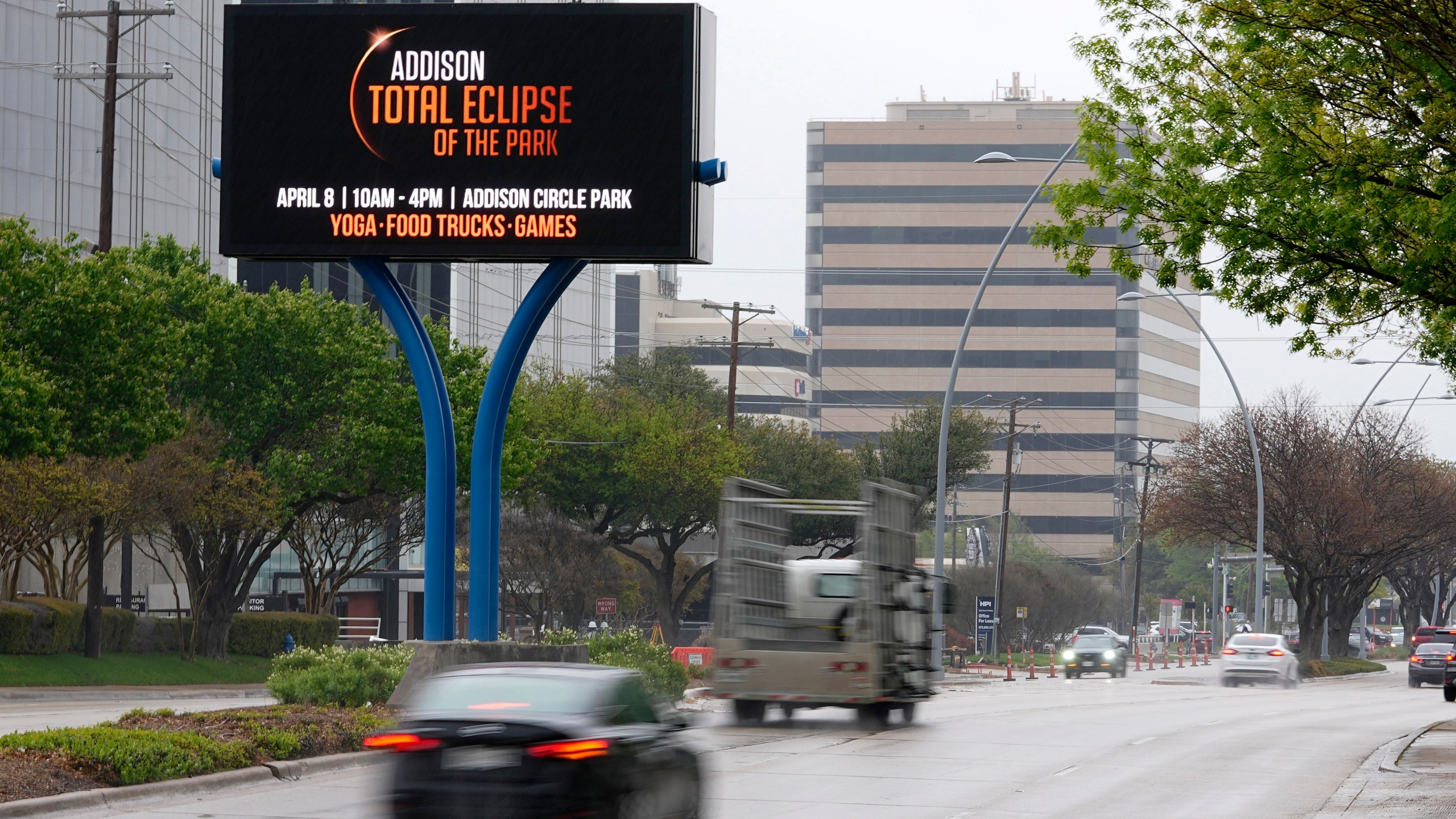 Information regarding the total solar eclipse is shown on a digital bill board as drivers make their way down a busy road in Addison, Texas, Thursday, March 21, 2024. (AP Photo/Tony Gutierrez)