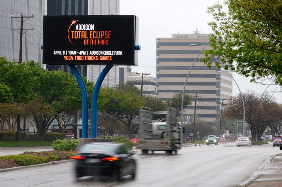 Information regarding the total solar eclipse is shown on a digital bill board as drivers make their way down a busy road in Addison, Texas, Thursday, March 21, 2024. (AP Photo/Tony Gutierrez)