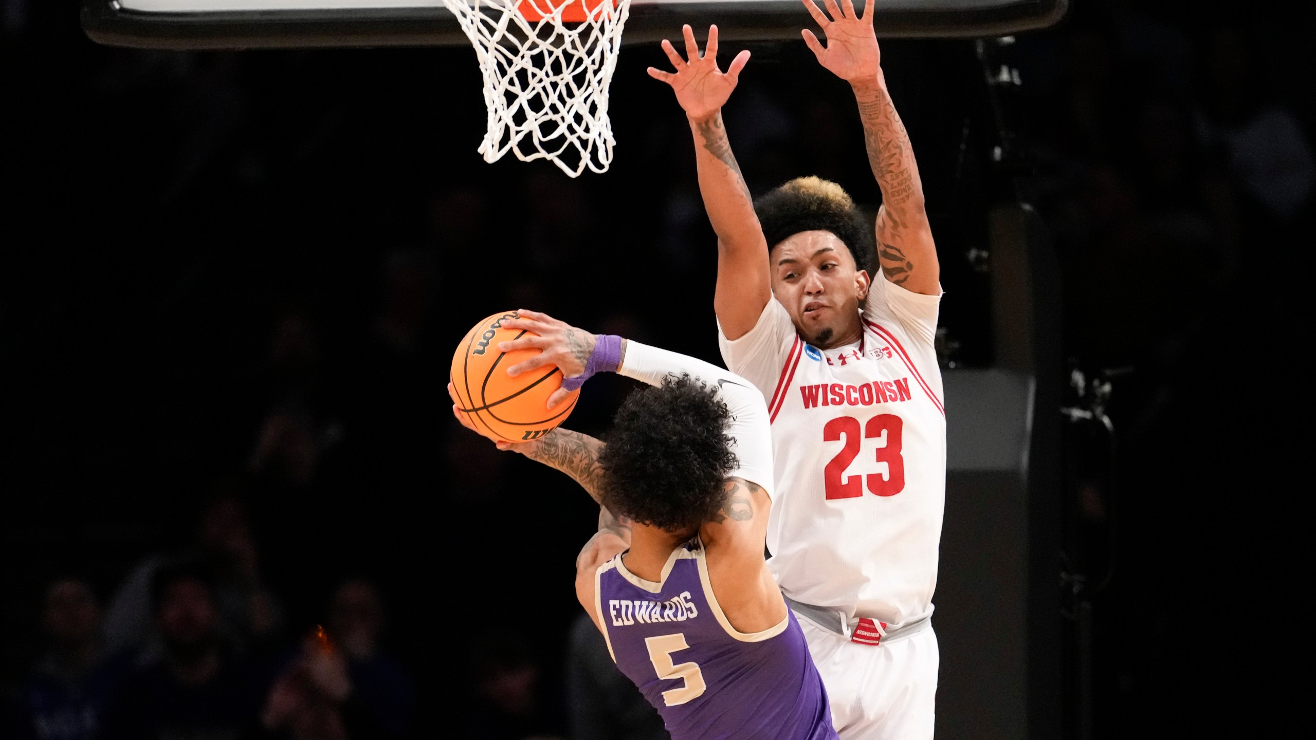 James Madison guard Terrence Edwards Jr. (5) goes to the basket against Wisconsin guard Chucky Hepburn (23) during the first half of a first-round college basketball game in the men's NCAA Tournament, Friday, March 22, 2024, in New York. (AP Photo/Mary Altaffer)