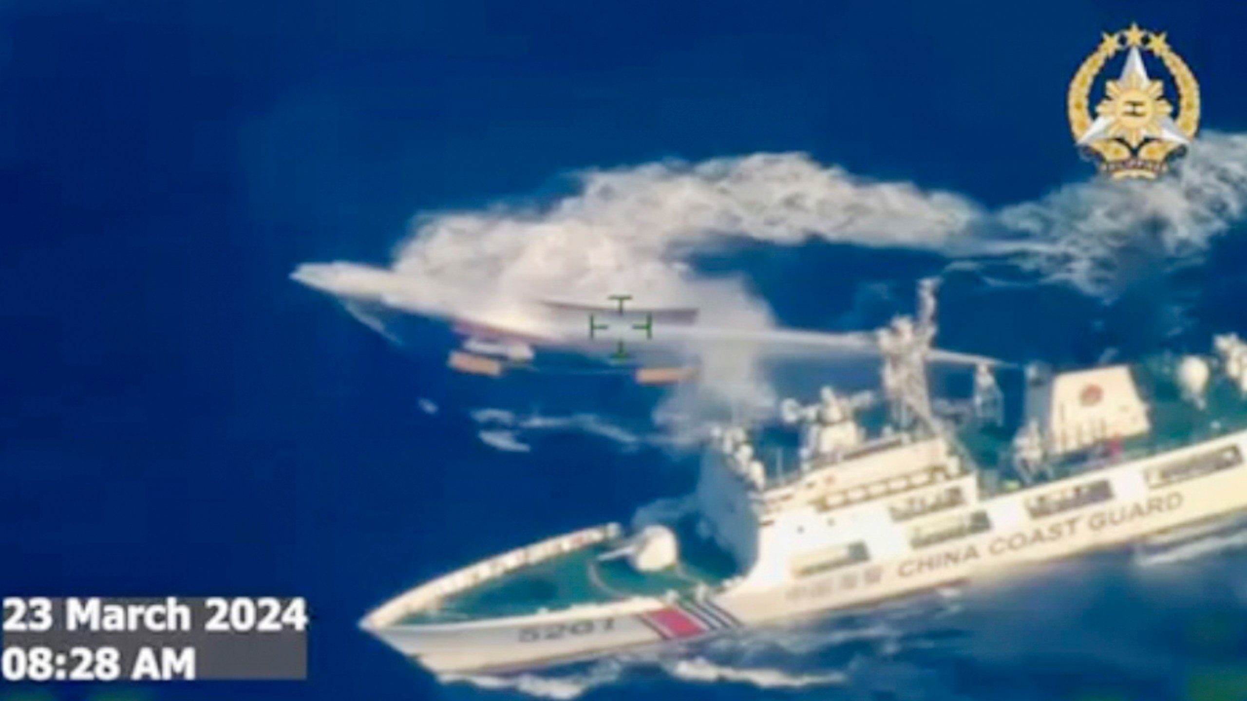 In this screen grab from video provided by the Armed Forces of the Philippines, a Chinese coast guard ship uses water cannon on a Philippine resupply vessel Unaizah May 4 as it approaches Second Thomas Shoal, locally called Ayungin shoal, at the disputed South China Sea on Saturday, March 23, 2024. (Armed Forces of the Philippines via AP)