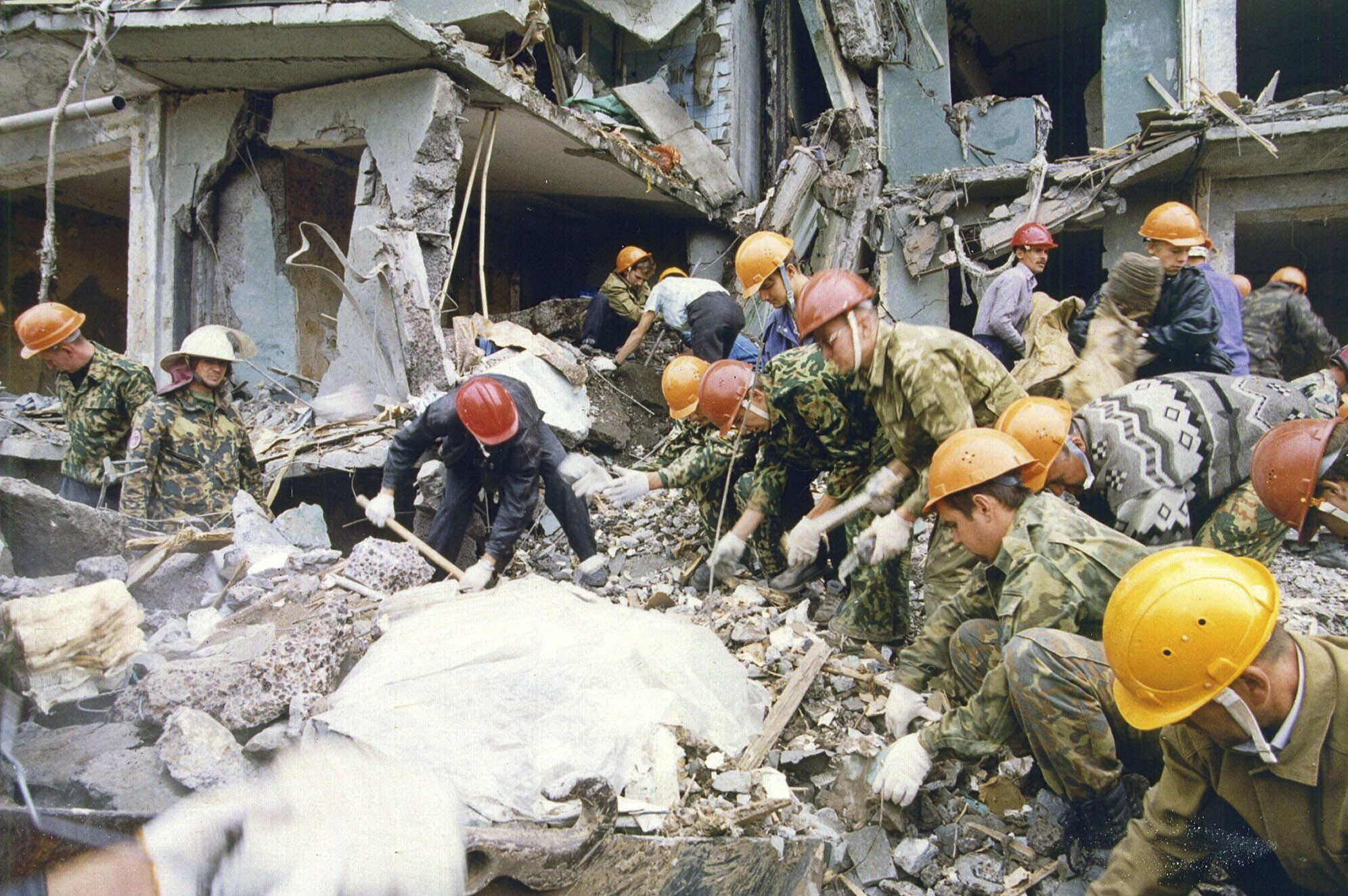 FILE - Rescue workers shuffle the rubble at a devastated apartment building in the city of Volgodonsk, close to Russia's Caucasus Mountains region, Thursday, Sept. 16, 1999. The attack on a Moscow concert hall in which armed men opened fire and set the building ablaze, killing over 130 people, was the latest in a long series of bombings and sieges that have unsettled and outraged Russians during Vladimir Putin’s nearly quarter-century as either prime minister or president. (AP Photo/Sergei Venyavsky, File)