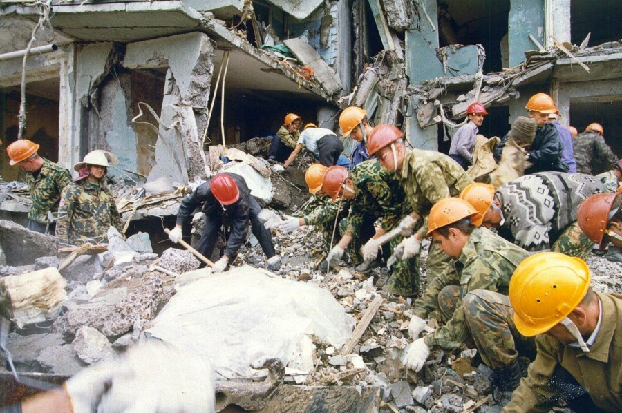 FILE - Rescue workers shuffle the rubble at a devastated apartment building in the city of Volgodonsk, close to Russia's Caucasus Mountains region, Thursday, Sept. 16, 1999. The attack on a Moscow concert hall in which armed men opened fire and set the building ablaze, killing over 130 people, was the latest in a long series of bombings and sieges that have unsettled and outraged Russians during Vladimir Putin’s nearly quarter-century as either prime minister or president. (AP Photo/Sergei Venyavsky, File)