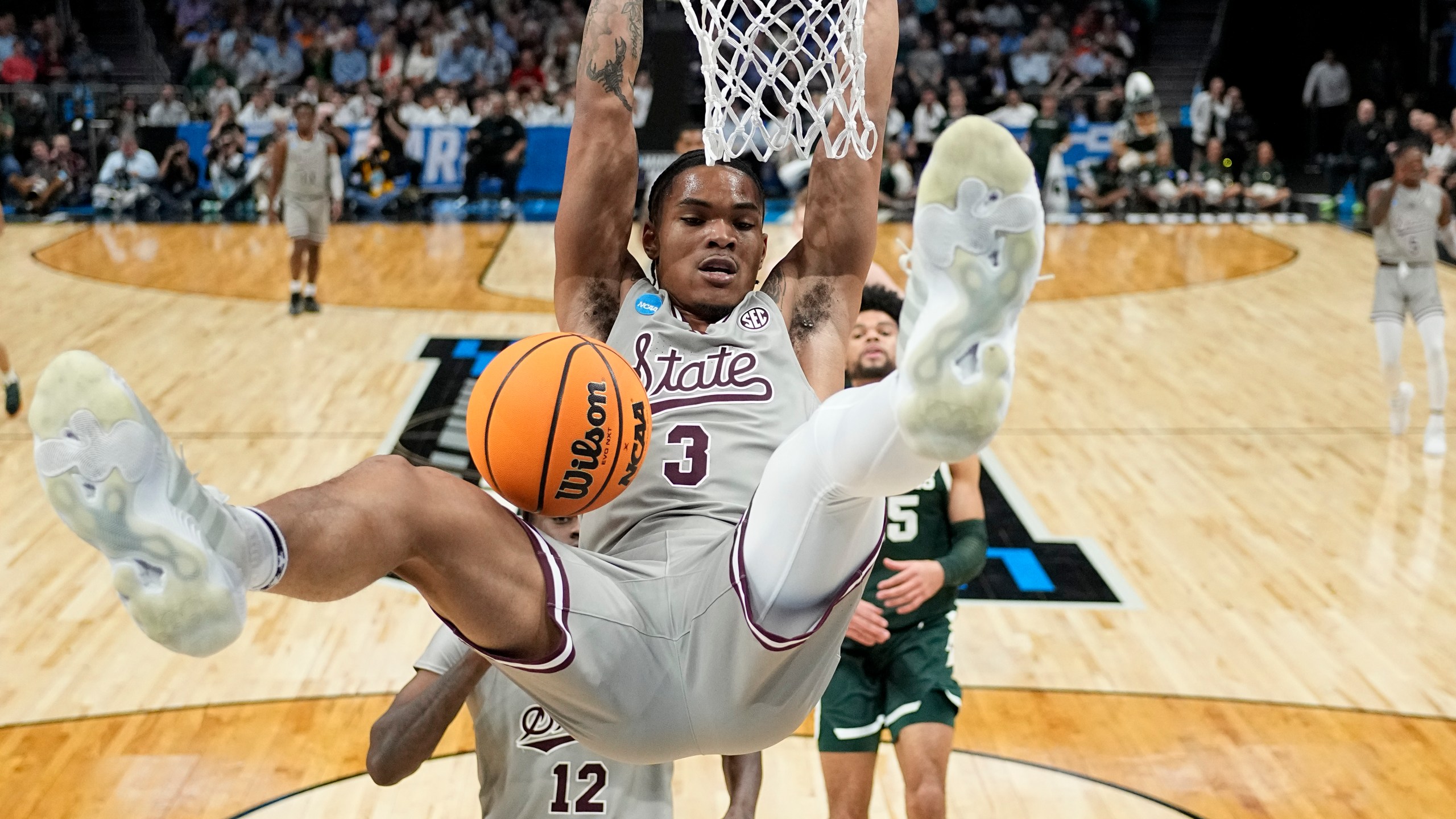 Mississippi State guard Shakeel Moore dunks against Michigan State during the second half of a first-round college basketball game in the NCAA Tournament, Thursday, March 21, 2024, in Charlotte, N.C. (AP Photo/Chris Carlson)