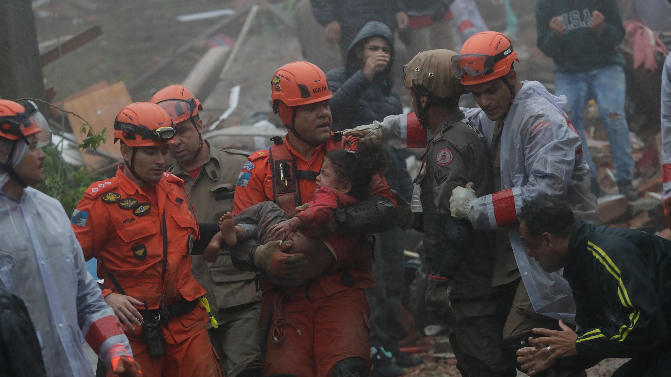 Rescue workers carry a 4-year-old girl who was rescued from her collapsed house after heavy rains in Petropolis, Rio de Janeiro state, Brazil, Saturday, March 23, 2024. (AP Photo/Bruna Prado)