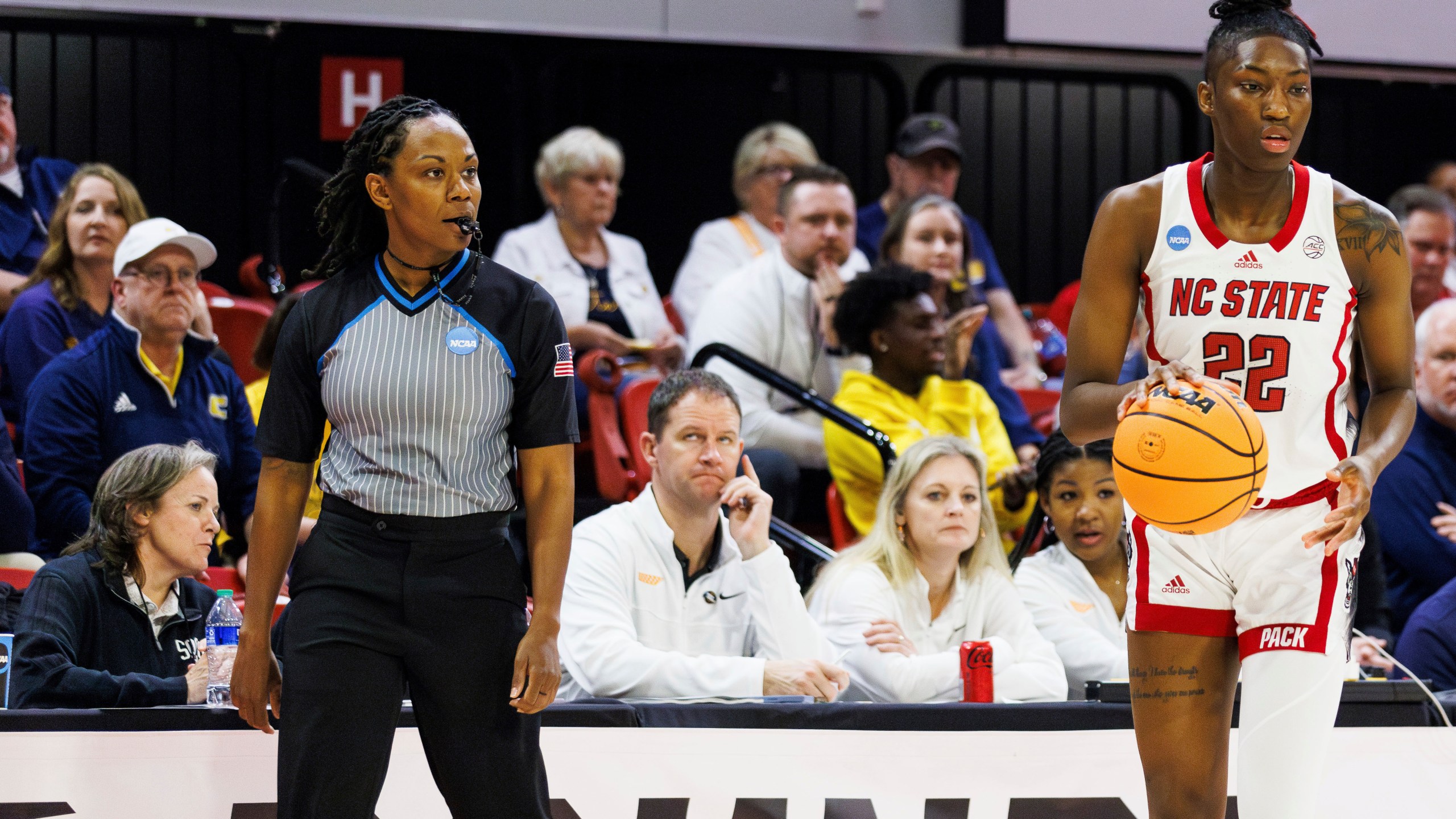 Official Tommi Paris, left, watches as North Carolina State's Saniya Rivers (22) handles the ball during the first half of a first-round college basketball game in the NCAA Tournament in Raleigh, N.C., Saturday, March 23, 2024. Paris was replaced at halftime by referee Angelica Suffren, who worked the earlier Green Bay-Tennessee game. NCAA representatives on-site didn’t provide a reason for the change. (AP Photo/Ben McKeown)