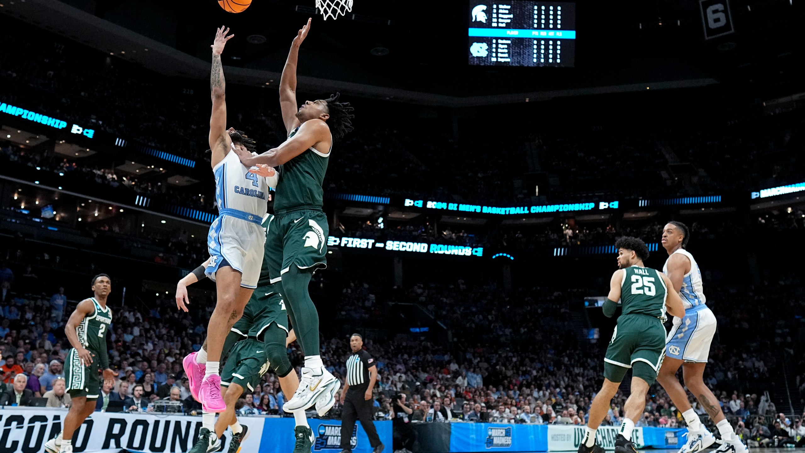 North Carolina guard RJ Davis (4) shoots over Michigan State guard A.J. Hoggard (11) during the first half of a second-round college basketball game in the NCAA Tournament, Saturday, March 23, 2024, in Charlotte, N.C. (AP Photo/Chris Carlson)
