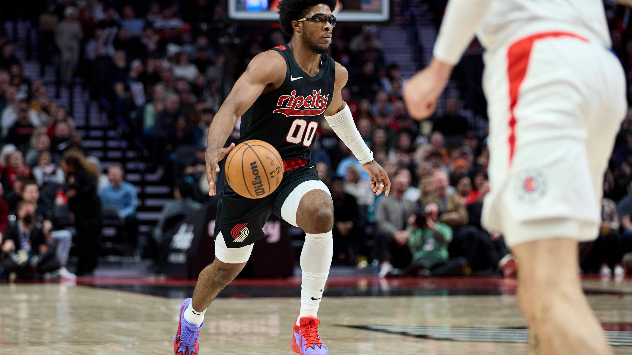Portland Trail Blazers guard Scoot Henderson brings the ball up against the Los Angeles Clippers during the first half of an NBA basketball game in Portland, Ore., Wednesday, March 20, 2024. (AP Photo/Craig Mitchelldyer)